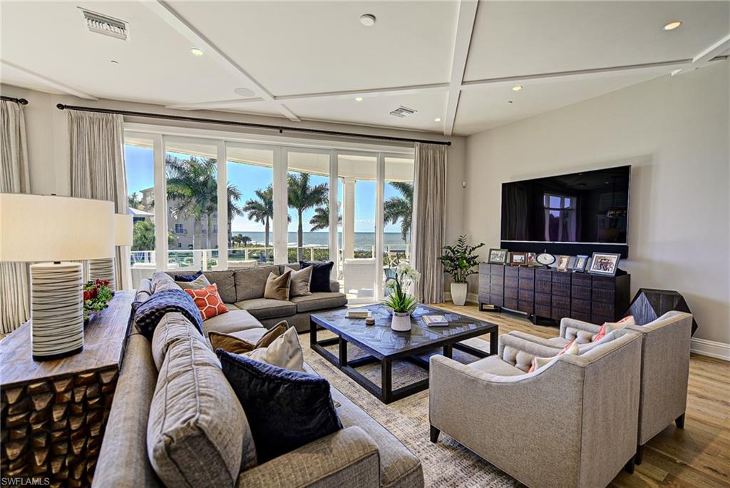 Stunning custom beach home.  This luxury residence is situated on a lot and a third.  Features direct SW exposure Gulf front lot in the largest of all the Barefoot Beach gardens. This 4-Story home offers a wide open feel on all levels due to the high quality of construction and has been professionally appointed top to bottom in an elegant coastal style. Layout includes 6 bed suites, his and her office space, top level cloud entertaining, and beach living and bar with 9 total baths. Includes grand wood staircase, elevator, high end gas appliances, electric screens, tasteful wide plank oak flooring, and large sit up butcher block kitchen island. Home also includes gas generator. Concrete and impact glass construction. Smart home lighting and numerous wet bars throughout. Includes garden heated pool, landscaped beach grounds, beach boardwalk, private clubhouse with fitness, tennis, and pickle ball. 24 hour patrolled security. Closest beach to international airport convenient to both Coconut Point and Naples entertainment.