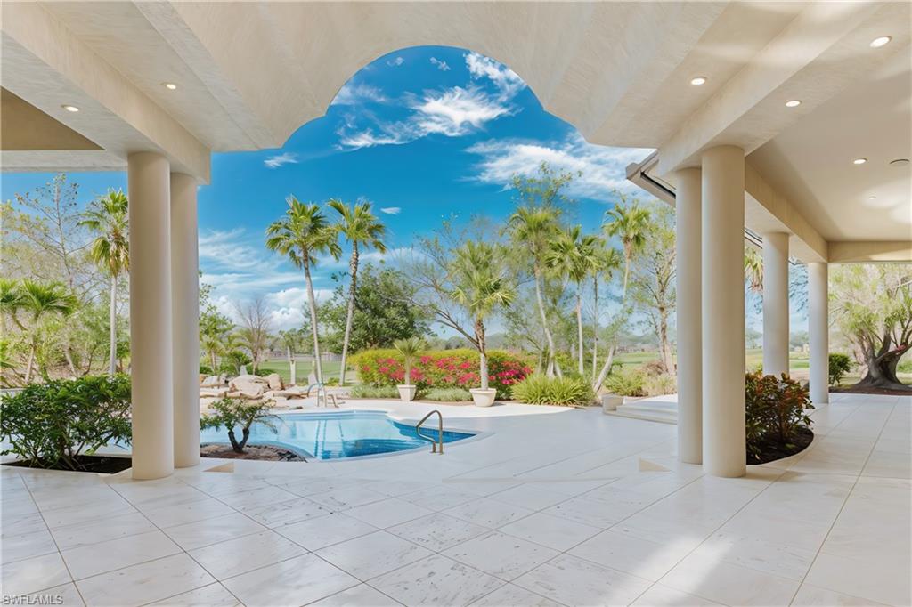 Discover an extraordinary masterpiece by Shane Ames, winner of Best Residential Architecture Firm in North America. Perched on two rare bi-shaped, elevated lots—the only raised lots in the community—this Italianate estate offers breathtaking golf course views, unmatched privacy, and timeless elegance. Designed for entertaining and refined living, the expansive open floor plan boasts high ceilings, sunlit interiors, and a gourmet kitchen with expensive custom-made Italian cabinetry, new countertops, and top-of-the-line appliances. The master suite, with its exquisite Portuguese marble flooring and spa-like bathroom, provides a serene retreat, while a separate guest house ensures added privacy and comfort for visitors. Step outside into your private tropical oasis: an entirely new resort-sized pool with updated equipment, tiles, and a soothing waterfall is the centerpiece of this stunning outdoor space. The spacious patio, cabana, and spa create the perfect setting for hosting gatherings or relaxing in style. With a brand-new roof, grand entrance, and freshly renovated interiors, every detail reflects modern luxury and meticulous care. Located just 10 minutes from pristine beaches and upscale shopping, this estate is both secluded and convenient. Opportunities to own a home of this caliber are rare—schedule your private showing today to experience the height of luxurious living! One or more photo(s) has been virtually staged, AI generated or rendered.