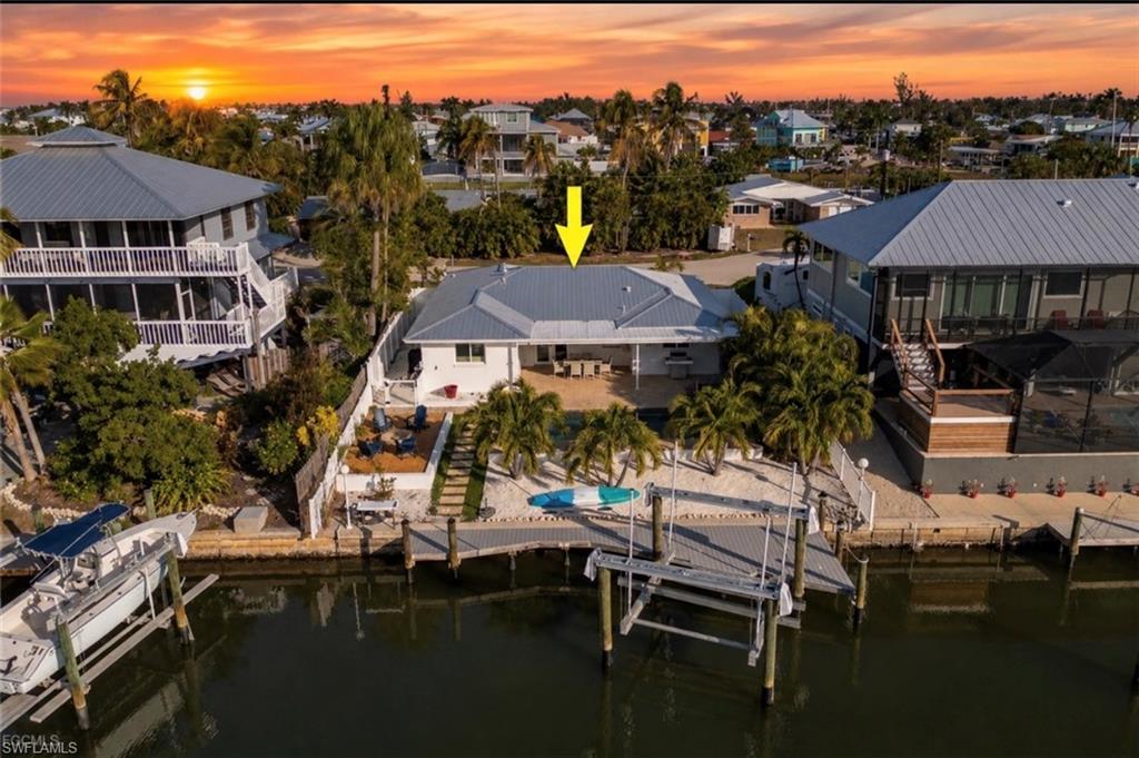 Welcome to your own private waterfront retreat! This beautifully redesigned 4 BEDROOM POOL home has been renovated from top to bottom with exceptional attention to detail. MAJOR updates include a NEW metal roof, impact-resistant windows & doors, spray-foam insulation, updated electrical and plumbing, a NEW A/C system, and all-new pool equipment, providing peace of mind for years to come. Inside, you’ll find elegant tile flooring throughout, a custom-designed kitchen, beautifully updated bathrooms, custom window treatments in every room, and abundant natural light enhanced by stylish modern lighting. Every space has been thoughtfully designed to blend comfort with sophistication. Step outside into your backyard paradise featuring a new saltwater pool, cozy fire pit, lush tropical landscaping, privacy fencing, a new seawall, and a 16,000-pound boat lift—perfect for enjoying Southwest Florida’s boating lifestyle. Located in the desirable Bayview Acres community, just minutes from open water, this property offers quick Gulf access while providing plenty of parking for guests, trailers, or recreational vehicles. Being sold turnkey furnished, this exceptional home is truly move-in ready. Simply bring your swimsuit and start enjoying everything waterfront living has to offer!
