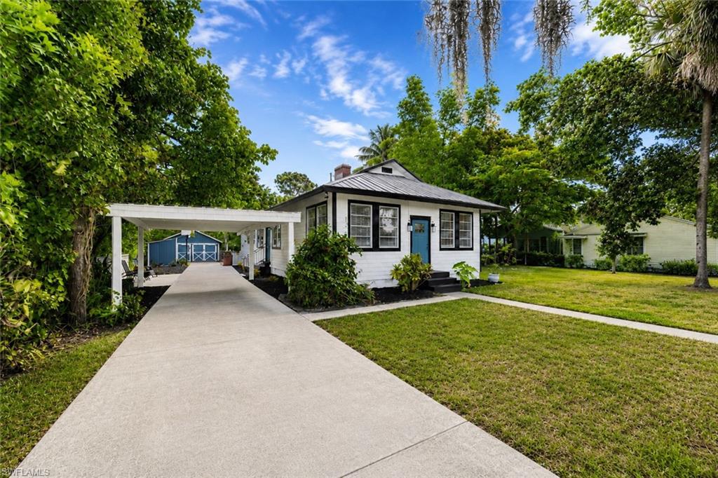 Welcome to one of the few historic homes in Bonita Springs, originally built in 1929, where timeless character meets thoughtful modern updates. Situated on a spacious, private lot, this charming raised ranch features original hardwood floors in part of the home, soaring ceilings, and three cozy fireplaces that create a warm and inviting atmosphere.

Major updates provide peace of mind, including a new metal roof, A/C, furnace, hot water heater, insulation, and fresh interior and exterior paint. Step outside to enjoy the fully fenced backyard, offering plenty of privacy and space to relax or entertain, along with a large detached workshop.

Ideally located just minutes from I-75, RSW Airport, and Southwest Florida's beautiful Gulf beaches, you're also just a five-minute walk to downtown Bonita Springs—now a rapidly emerging hotspot with new restaurants, entertainment, coffee shops, boutique shopping, ice cream, live music, and significant investment transforming the area.

With no HOA, low property taxes, affordable insurance, and no flood insurance required, this home has remained high and dry, offering added peace of mind. Whether you're looking for a primary residence, seasonal retreat, or a high-potential investment property, this home offers exceptional flexibility with no rental restrictions. Its prime location in one of Southwest Florida's fastest-growing downtown districts creates outstanding opportunities for long-term appreciation as well as income-producing rental potential, making this a rare chance to own a piece of Bonita Springs history while investing in its exciting future.