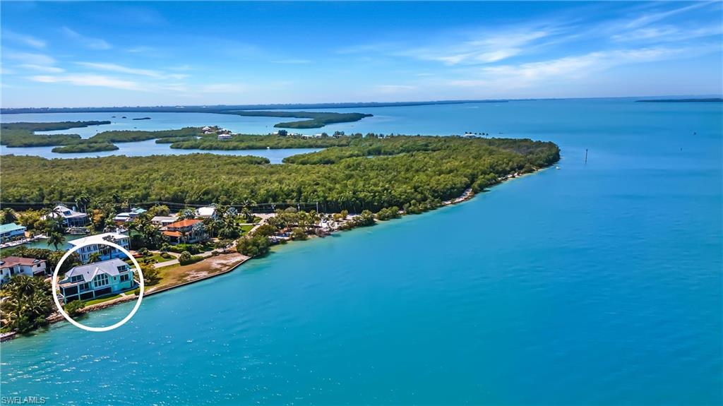 Sale includes dock with 14,000-pound lift plus water and electricity. Located at 1545 San Carlos Bay Drive, it is a separately deeded strip of land with a newly built composite dock on direct access canal. It is rare to have a bayfront home with dockage and this home delivers both. Just outside your door are crystal blue waters and mangrove islands for as far as the eye can see. To the west extends protected natural lands owned by the City of Sanibel and U.S. Fish and Wildlife. With a wall of windows and balconies overlooking the waters of San Carlos Bay, the bay is your backyard, and the serenity of nature keeps you present with a constant display of fish, dolphin, birds and manatee. Built in 2016 with durability and safety in mind, this house was constructed to weather any storm. Luxury upgrades include elevator, wood flooring, chef's kitchen with Thermador appliances and Miele built-in coffee machine, central vacuum, security system, heated pool and spa, and tackle room. See attached spec sheet for complete details.