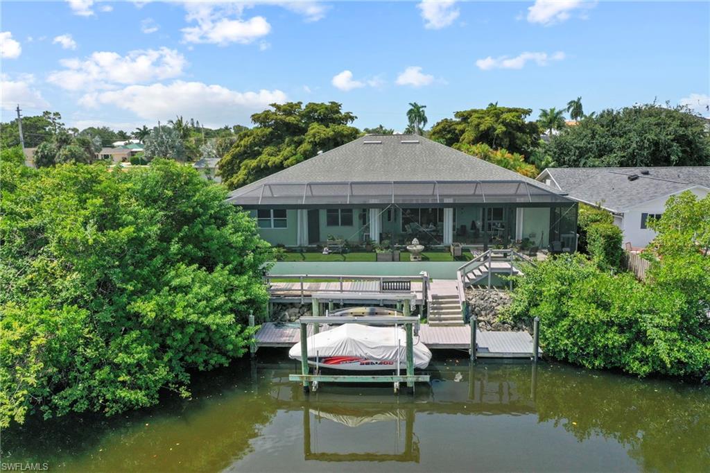 Welcome to the boating community of Little Hickory Shores in Collier County! Experience the ultimate Southwest Florida waterfront lifestyle with direct Gulf access. Launch from your private oversized dock and boat lift and enjoy effortless, bridge-free navigation to the Gulf of Mexico, where endless boating, fishing, shelling, and spectacular sunsets await. Beautifully renovated from top to bottom. On the exterior you'll find newly installed Tesla solar panels giving you the peace of mind of having "whole house" power at all times and a propane tank for cooking. Hurricane windows and shutters complete the safety and security of your new home. The two car garage has an electric vehicle plug-in. The attic has its own exhaust fan system keeping the house even cooler. Relax on this huge screened in lanai with new no-see-um panoramic screens. Are you a gardener? This home has a separate potting room with a sink off the lanai. Lush landscaping surrounds the property and has a brick paver driveway with plenty of parking. The heart of the home is this stunning chef-inspired kitchen, featuring rich espresso cabinetry, gleaming Cambria countertops, stainless steel appliances, a Monogram professional gas cooktop, built in oven/microwave, large breakfast bar and an oversized center island with prep sink and abundant storage. Filled with natural light from expansive windows and 10' ceilings with crown molding. Wet bar. The open-concept layout connects effortlessly to the main living areas, creating the perfect space for everyday living and entertaining. Warm wood-look flooring and stylish contemporary lighting complete this sophisticated yet welcoming design. The Owner's suite is very private, split form the other bedrooms and has a den/sitting area with its own air conditioner. The interior laundry is complete with high efficiency GE large capacity appliances, lots of cabinets and a laundry sink conveniently located inside under air conditioning. 
The entire house has high end fixtures and all new flooring/kitchen/baths and lanai.
Pre-wired for a future in home vacuum system and pre-wired for a sound system.
This spacious home is in move-ready condition and the one to see today!