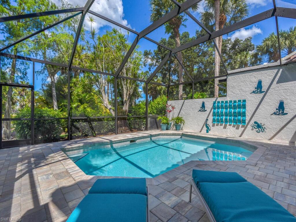 Looking for a golf membership? This home has a golf membership available! Eagle Creek was recently voted Best Golf Course and Tennis Facility in Gulfshore Life Magazine. This beautiful villa pool home is being sold turnkey furnished and ready to move right in. Enter the home through the tranquil courtyard, as you walk through the front door the inviting entry flows into the spacious great room, with soaring ceilings, fireplace and sliding glass doors to the lanai and pool area, this room is the heart of this home. Step out onto the newly paved pool deck and enjoy the beautiful views of the lake and golf course. 
The home's stunning wood floors extend through the living areas and up the stairs to the private master suite, where a private balcony affords fantastic views of the luscious golf course. Situated on the first floor the guest bedroom, guest bathroom and den could easily be closed off to form another master suite if desired. Enjoy the great location between Marco Island and Downtown Naples with stores such as Fresh Market and Home Depot directly outside the community.