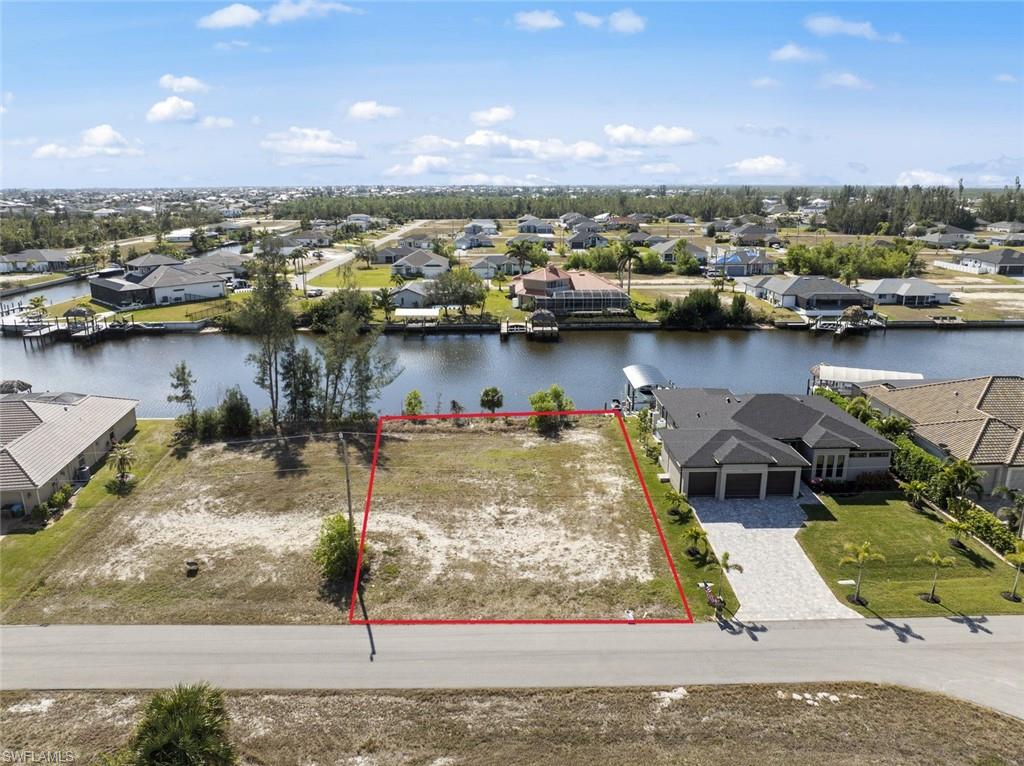 WIDE WATER VIEWS. SOUTHERN EXPOSURE.  DIRECT, BRIDGELESS GULF ACCESS. This exceptional waterfront homesite overlooks a 200-foot-wide canal that flows into beautiful Laguna Lake, offering a more open, expansive feel than the typical Cape Coral canal. Launch your boat from your backyard and enjoy effortless, bridge-free access to the Gulf of Mexico, with world-class fishing, waterfront dining, island beaches, and endless boating adventures just minutes away. Located in one of NW Cape Coral's fastest-growing areas near the exciting Seven Islands development, this property is the perfect place to build your dream home or invest in one of Southwest Florida's most desirable waterfront lifestyles. Opportunities combining wide water views, southern exposure, and direct Gulf access are becoming increasingly hard to find.