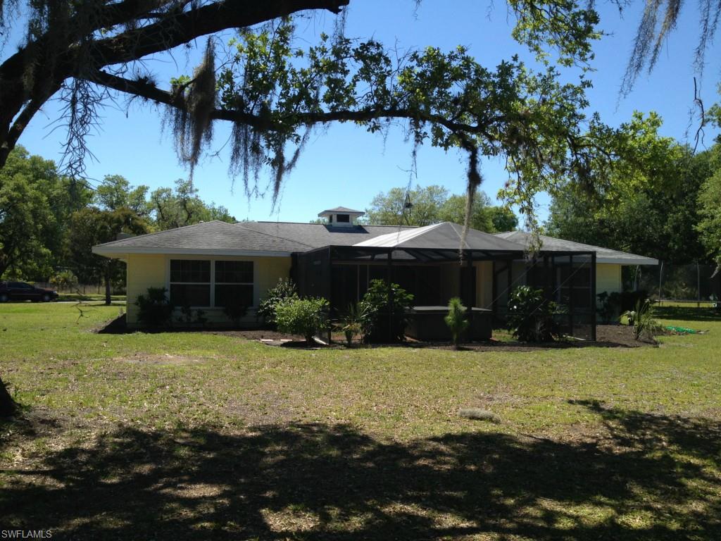 Beautiful courtyard home set on five acres in the heart of Alva.  Your new home has over 2,250 sq. ft. of living space and very large room sizes.  Upgrades abound.  Completely new island kitchen with granite counter, efficient LED lighting and new appliances.  Wood flooring throughout kitchen, dining, and enormous great room, which has four sliders opening to the screen enclosed courtyard with hot tub and built in BBQ.  Enjoy the peace and tranquility this home offers.  Additional features include: a new whole house reverse osmosis system, two master suites which open to courtyard, three full bathrooms, new a/c system, cedar walk-in bedroom closets, large indoor laundry room, two extra rooms to use for home office, den, or media room.  On the outside the home has a newer roof and the entire property is fenced.  There is a 2,480 sq. ft. (40' x 60') commercial grade steel beamed garage/barn with 12' door opening.  Garage has workshop with walk-up storage loft above.  Plenty of room for RV, trailer, car and boat storage.  Land is well drained and irrigated,  and has many stately oak trees and fruit trees.  There are four wells and three septic fields, and room for horses or cattle.