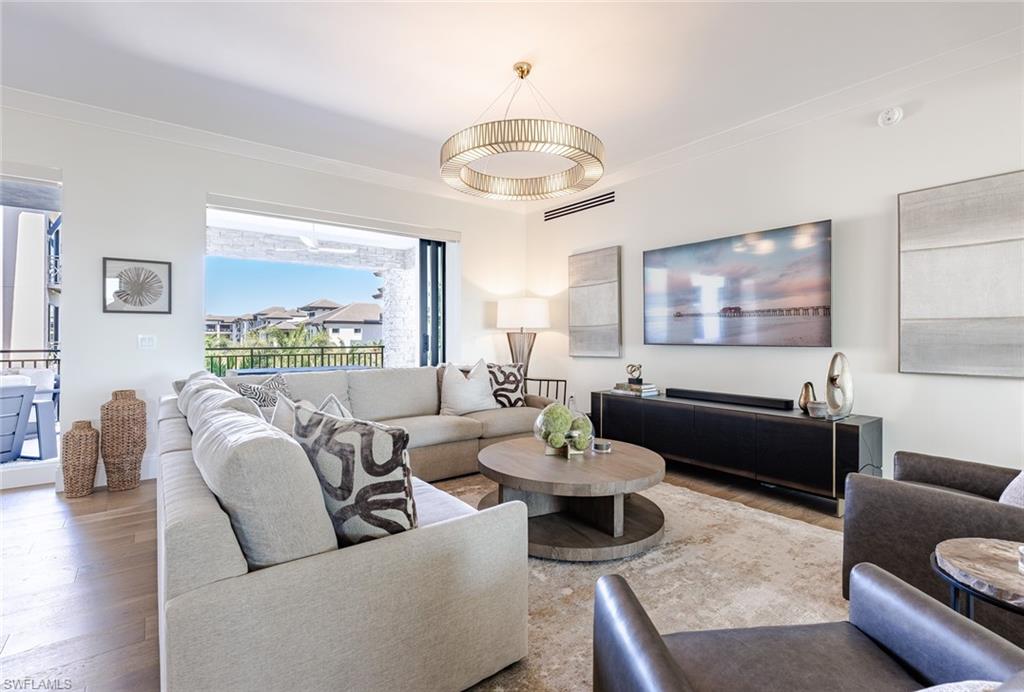 Experience elevated urban living at Quattro at Naples Square, ideally located in the vibrant heart of Downtown Naples. This move-in-ready, newly constructed fourth-floor Espada residence offers over 3,350 square feet of thoughtfully curated living space, featuring four bedrooms plus a den and four-and-a-half baths.

Designed with both sophistication and comfort in mind, the open-concept layout is enhanced by 10-foot ceilings, impact-resistant doors and windows, and expansive living areas that flow seamlessly to two generous balconies overlooking beautifully landscaped grounds. The spacious great room connects effortlessly to a private den and an impressive gourmet kitchen equipped with premium Sub-Zero, Wolf, and Miele appliances, natural gas cooking, striking quartz countertops, custom cabinetry, luxury wood flooring, and a stylish wet bar complete with an under-counter beverage cooler—perfect for entertaining.

This residence includes two secure parking spaces with EV charging capability and a dedicated storage unit within the gated, covered garage for added convenience.

Quattro at Naples Square delivers a refined, resort-style experience with amenities that include a sparkling pool and spa, a state-of-the-art fitness center, and an elegant social lounge featuring a full catering kitchen, billiards table, and large-screen televisions. Just steps from iconic 5th Avenue South, world-class dining, upscale boutiques, and the pristine white sand beaches of Olde Naples, this exceptional residence offers the ultimate blend of luxury, lifestyle, and location.