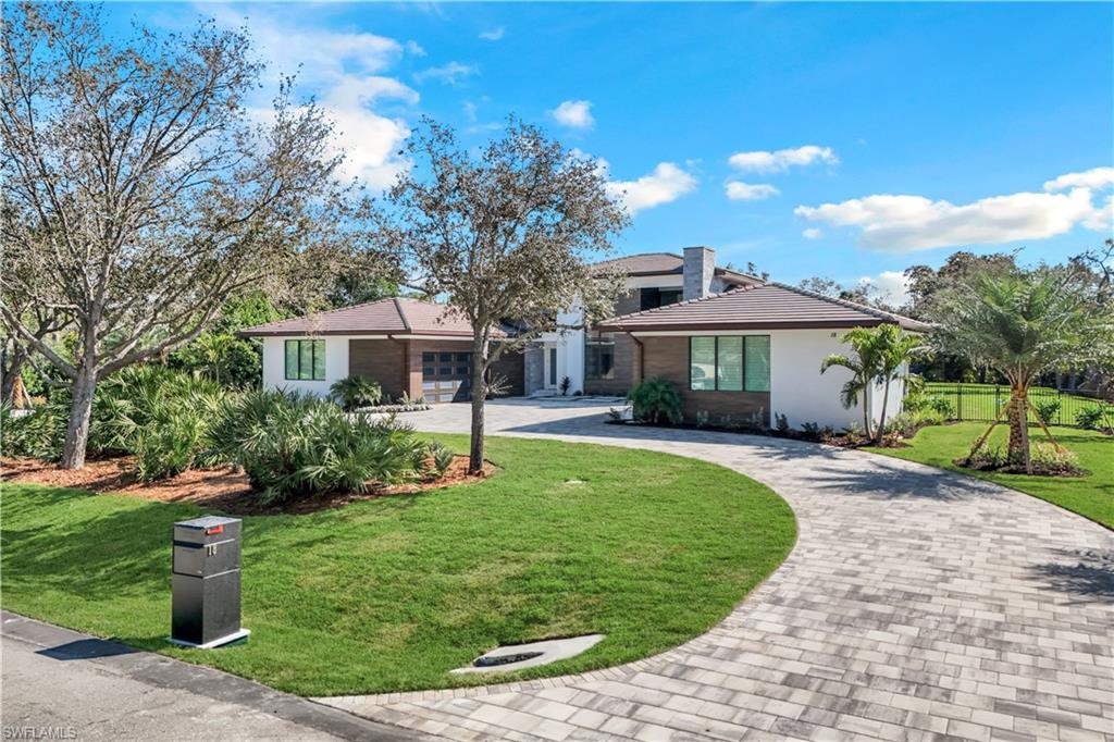NEW CONSTRUCTION WITH WARRANTY- FURNISHED & READY FOR OCCUPANCY - Located on over an acre of land in Pine Ridge, yet less than 2 miles to the beach, this custom home by Arthur Rutenberg Homes features a modern design with luxurious warmth.    The main house features a spacious great room, gourmet kitchen, casual dining area, 3 ensuite bedrooms, a den, flex room, prep kitchen, home delivery center and 4 car garage. Attached by an extended covered cabana and outdoor kitchen is a Casita that offers a private bedroom, bath, kitchen and living room..... perfect for visiting family.   With over 900 sf of covered outdoor living space surrounding the resort style pool/spa, outdoor kitchen and fireplace, this home is perfect for entertaining family and friends.