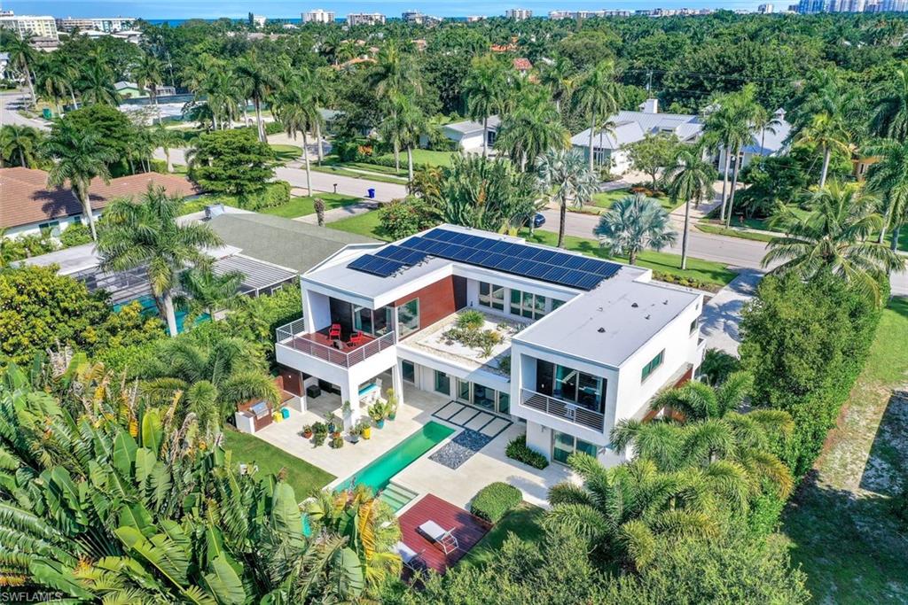 Coastal and modern influences blend effortlessly with a focus on sustainability, making this home truly exceptional. Its innovative design features photovoltaic solar panels, a rooftop garden, and a highly efficient 4 Zone HVAC system, complemented by a whole-house generator and smart lighting design. The home boasts elegant finishes in earth tones of white, gray, and stone, seamlessly transitioning from exterior to interior.
The open gourmet kitchen, complete with custom Poggenpohl cabinetry, Quartz countertops, and top-of-the-line Wolf-Subzero-Bosch appliances, centers around an oversized island with ample seating for entertaining friends and family. Generous pocket sliding doors span the entire rear of the home, creating a seamless flow to the outdoor living space, which includes a pool, outdoor kitchen, landscape lighting, and lanai with retractable screens.
The master suite offers a private terrace and two large custom walk-in closets, while the master bath evokes a spa-like ambiance with its tranquil design and transom windows for natural light. Additionally, two spacious guest bedrooms—all with ensuite baths, walk-in closets, and private balconies—ensure comfort and privacy for guests. One guest bedroom and an office are conveniently located on the first floor.
Situated just minutes from the beach, shopping, and restaurants, this home offers the perfect blend of luxury and convenience.