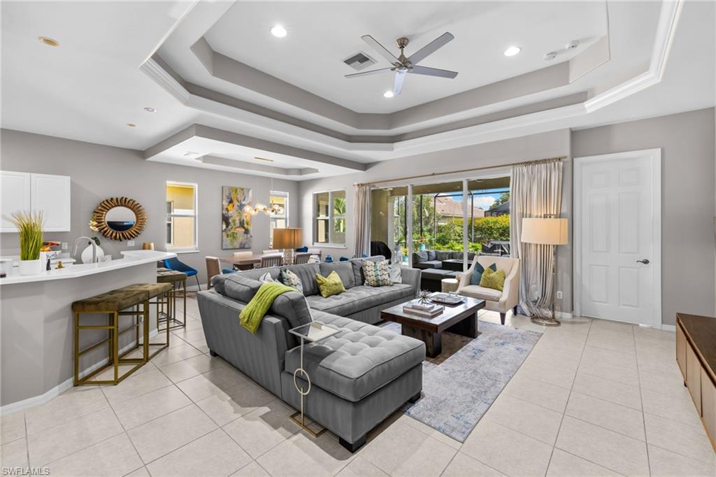 Luxury living at its finest awaits in this stunning three-bedroom, two-bath residence, perfectly situated on a premium estate lot in one of North Naples' premier gated communities. Sun lovers will appreciate the highly desirable southern exposure, bathing the home in beautiful, natural light all day long. Thoughtfully designed, the floor plan features a fantastic open-concept kitchen that flows seamlessly into the great room, perfect for effortless entertaining. Durable tile flooring spans throughout the entire home, complementing the soaring vaulted ceilings. Enjoy ultimate privacy with a split-bedroom layout, including a clever pocket door that separates the guest bedrooms and second bath into a completely private retreat for family and visitors. Right outside your front door, a rare and spacious additional side yard provides the perfect manicured green space for kids and pets to play. Situated in Longshore Lake, residents enjoy an exceptional lifestyle centered around an 88-acre freshwater lake with seven miles of scenic shoreline—making kayaking, paddle boarding, fishing, and electric boating steps from your door. The neighborhood features country-club-style amenities, including nine lighted Har-Tru tennis courts and four pickleball courts with a resident Tennis Pro. A vibrant lakefront clubhouse serves as the community's social hub, featuring fine and casual dining, an outdoor pub, and a packed social calendar. Active living is effortless here with a state-of-the-art fitness center, a heated resort-style pool and spa open 365 days a year, a children's playground, and a scenic 2.6-mile walking and jogging path circling the neighborhood. Perfectly positioned for ultimate convenience, this pristine home is just minutes from everyday grocery stores, premier shopping, championship golf courses, and upscale dining. Best of all, you are just a short drive from the renowned white sand beaches of Naples, offering the perfect balance of tranquility and convenience. Experience a lifestyle few communities can match—schedule your private tour today!