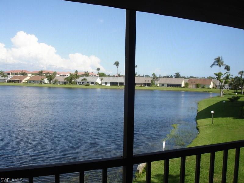 WOW! WHAT A VIEW!  Very nice second floor unit on the LAKE.  Kitchen cabinets updated,  bathrooms have new vanities, granite, newer tile floors and there are hurricane shutters.  One of the four community pools is directly in across from the building.  Condo fee is $345 mo.  Popular CINNAMON COVE has a full time activities director and so close to beaches, restaurants and shopping.  Lots of amenities including clubhouse, 4 pools, hot tub, pickle ball, tennis, shuffleboard, bocce, fitness and more. NOT in 55+ section.