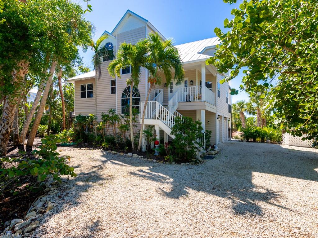 Experience spectacular views, privacy, and serenity from this incredible near- beach elevated pool home. Overlooking the expansive native greenery of Bowman's Beach Park with partial views of the Gulf beyond, this home boasts an incredible location with quick and easy access to Sanibel's amazing west end beaches. World-renowned shelling is literally in your backyard! Southern exposure, tall ceilings and abundant windows create a cheerful and inviting living space. The open kitchen features white wood cabinets, quartz countertops, new stainless steel appliances, and a large pantry. Occupying the top floor, the primary suite is fantastic. The newly renovated custom bathroom has a double vanity, huge walk-in tile shower and luxurious soaking tub. The sun porch off of the bedroom affords some of the best views in the house. Multiple porches and extensive outdoor living space surround the custom pool area which includes a spa and spacious sun shelf. An enclosed staircase from the lower level garage and a three story private elevator provide added convenience. With a lovely combination of native and tropical plantings and a long stone driveway, this is a property to welcome you home!
