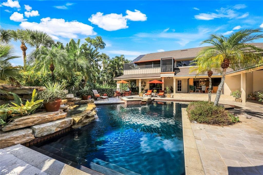 Set across two private, meticulously landscaped lots inside the guard-gated Fiddlesticks Country Club, this nearly 10,000 sq. ft. custom Rutenberg estate was crafted in collaboration with six architects to create a residence where luxury, craftsmanship, and livability meet in perfect harmony. From the moment you step inside, the home unfolds like a private resort. Sunlight pours through grand architectural windows, illuminating 20-foot beamed ceilings, a dramatic stone fireplace, and multiple gathering spaces designed for unforgettable moments from the elegant salon to the warm, soaring great room. The chef’s kitchen is a showpiece of function and beauty, featuring paneled Sub-Zero, Thermador, and Dacor appliances, a walk-in pantry, and effortless flow for both intimate dinners and large-scale entertaining. The primary wing feels like its own world with dual walk-in closets, a spa-style bath, and a private executive office creating a sanctuary for both rest and focus. Guests are treated to luxurious ensuite bedrooms, a shared retreat with a clawfoot tub, and resort-like amenities including a home gym, sauna, and multiple entertainment bars for evening cocktails or weekend gatherings. Wall-to-wall sliders connect the interior to an extraordinary outdoor living experience. Overlooking sweeping views of the 7th green and 8th tee, the lanai is anchored by a heated saltwater pool, waterfall, spa, and swim-up bar, framed by lush tropical landscaping and complete privacy. This is scale, soul, and sophistication,  beautifully lived. With a 4-car garage, whole-home upgrades, and the exclusivity of one of Southwest Florida’s premier golf communities, this is more than a residence - it’s a once-in-a-lifetime estate offering unmatched scale, craftsmanship, and prestige. A home impossible to replicate today and unforgettable from the moment you arrive.