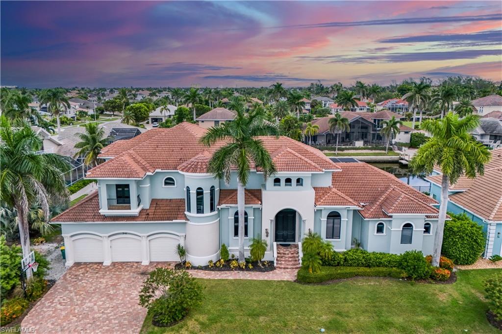 Waterfront Gulf-access pool home on wide Marco Island canals featuring a heated pool, spa, and newer dock with boat lift and platform lift. This luxury coastal retreat offers an open floor plan filled with natural light, walls of glass, and seamless indoor-outdoor living designed for connection and comfort. Tucked along one of Marco Island’s most desirable waterways, the home captures the essence of Florida waterfront living. Enjoy mornings with coffee by the pool, afternoons on the boat, and evenings surrounded by glowing sunsets. Inside, the chef’s kitchen with granite countertops, stainless-steel appliances, and bar seating flows effortlessly into the living and dining areas, perfect for entertaining. The primary suite feels like a private resort, offering water views, a spa-inspired bath, soaking tub, and walk-in shower. Step outside and the lanai becomes a year-round escape with covered dining, lounging areas, and panoramic water views. With Gulf access, you are  ready for boating adventures, dolphin watching, and sunset cruises. Located just minutes from pristine beaches including Tigertail, award-winning restaurants, boutique shopping, and local parks. Whether you’re seeking a full-time residence, seasonal escape, or luxury vacation rental investment, this Marco Island home embodies relaxed elegance, thoughtful design, and the beauty of Florida coastal living.