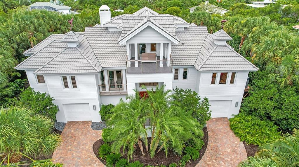 Located on an oversized lot w/direct access canal & dock on prestigious Lighthouse Way, this home was renovated in 2018/2019. Coastal contemporary home w/interior design by Dwayne Bergman Interiors. Concrete construction (first two levels). New kitchen, bathrooms, hand-painted white oak flooring. Primary suite is breathtaking, huge primary bath w/high-end finishes. Custom closet w/built-ins - biggest closet you've ever seen. Living room w/fireplace & wet bar. Contemporary kitchen offers Cambria countertops, center island, custom cabinetry, high-end appliances & large hidden pantry - all open to living room. Custom his & hers home office w/balcony.
Large, heated saltwater pool w/spa & brick decking and 2-story screened enclosure (new as of 2019). Home is wind mitigated & features all the latest technology. Spacious screened lanai, two guest bedrooms, sundeck, glass stairway. Lots of lower-level storage. Like new & priced to sell. Completely furnished. One of a kind opportunity!