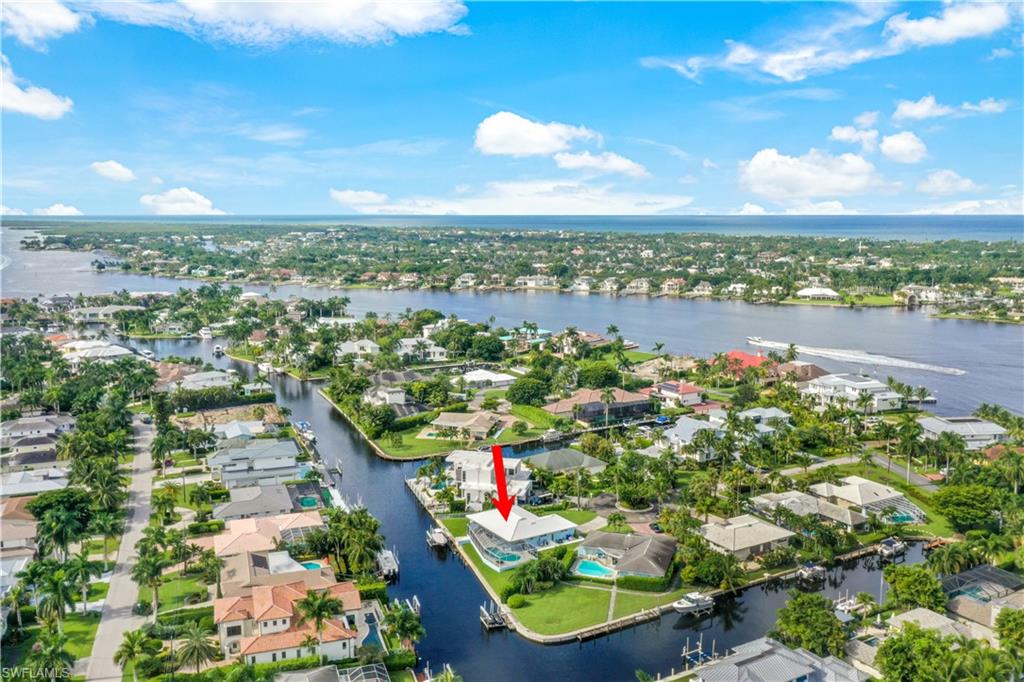NO FLOODING OR DAMAGE! $400,000 PRICE DROP! MOVE-IN READY, TURNKEY FURNISHED, 20,000# BOAT LIFT, NEW KITCHEN! Spectacular 172 ft. of WATER FRONTAGE on a rare and coveted Tip Lot, sits this beautifully updated, move-in ready home! 172’ is the longest waterfront expanse on the market in Royal Harbor! The community, on Naples Bay, offers deep water, direct, no bridge Gulf access, minutes to 5th Avenue and the Beach! Long water views, wide canal, 20,000# Lift, and room for more boats and jet skis, make this home a Boater’s Playground! At the cul-de-sac, the light filled home, with new AC, is perched on a high lot with no traffic. Walk past the pristine landscaping, through the glass entry doors, to an open bright, casual living area and study or dining. The new kitchen was just completed with stainless appliances, gorgeous blue tiled wall, sharp hardware, and a triple window above the sink with views of the pool and water below. The master suite features dual closets, and a private water closet. Guest bedrooms are separate from the Master. Generous outdoor- living, features a sparkling updated pool and new deck. Step down to your boat that is for sale, for new adventures in paradise!