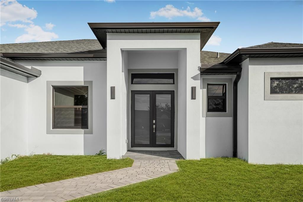 Introducing a stunning example of contemporary luxury living: this beautiful new construction boasts a modern aesthetic that is both chic and functional. Step into the spacious kitchen, featuring a sleek island with high-end stainless-steel appliances and quartz countertops, perfect for cooking and entertaining. European-style acrylic cabinets provide ample storage, complementing the clean, minimalist look. Throughout the home, porcelain tile flooring adds elegance and durability. In the bathrooms, LED light mirrors combine style with practicality for a truly indulgent experience. With four bedrooms and two and a half bathrooms, including a master suite with his and her sinks and an elegant tub, comfort and luxury abound. From the floating modern vanities to the acrylic European style closet doors, every detail has been carefully curated for modern living at its finest. And with an extended lanai and sleek finishes, calling this paradise is an understatement.