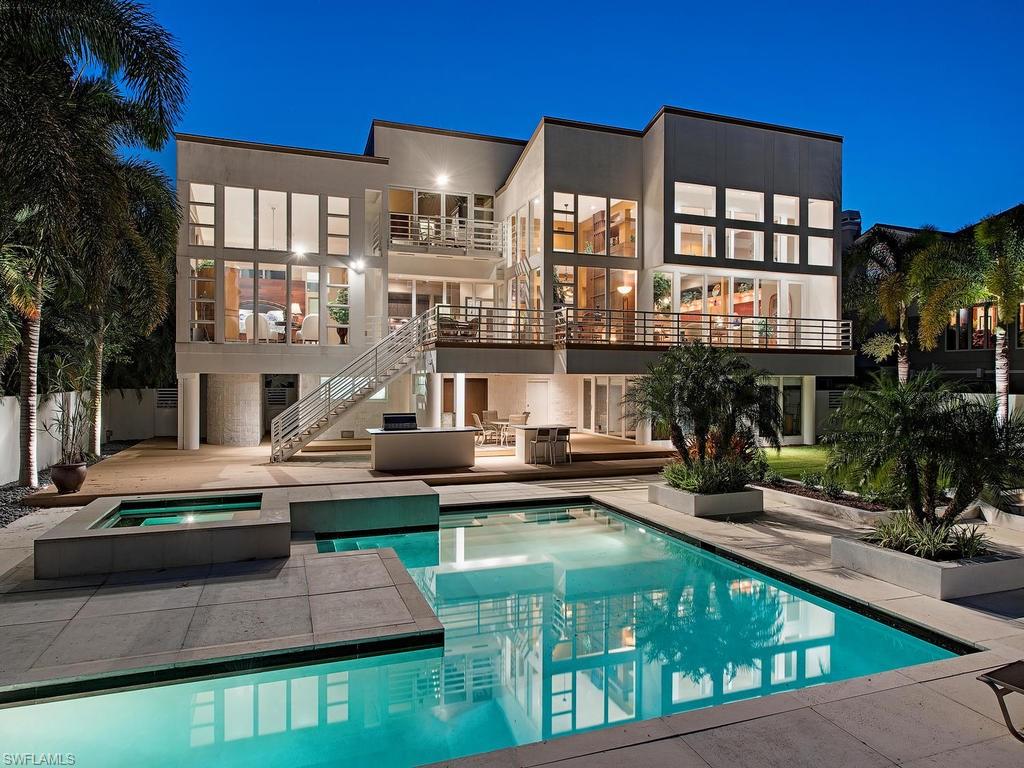H.11828 - Contemporary masterpiece thoughtfully designed with 14’ soaring floor to ceiling glass windows offering wide water views of Aqua Cove in Aqualane Shores and encapsulating the home with an abundance of natural light. Completely renovated and updated by Hemmer Construction with beautiful finishes and a minimalist design and clean lines. This home boasts gorgeous hardwood and marble floors throughout, exquisite gourmet styled kitchen, beautifully designed two-sided linear fireplace, and much more. Deep water yacht basin plus a boat slip with boat lift/3 Jet Ski lifts and a 3 car collectors garage. This home is ideally situated two blocks to the beach and two blocks to Third Street.