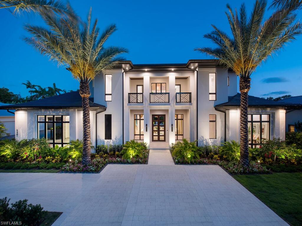 Located in Old Naples on a Southern exposure oversized 100x150 lot just blocks to the Gulf of Mexico beaches and entertainment district of 5th Avenue South, this new home has 5 bedrooms and 6 baths with 6,219 sq. ft. under air and 8,841 sq. ft under roof. The open floor plan opens to two separate outdoor living spaces with electric screens and shutters, a large resort style pool with spa, fireplace, summer kitchen, fire pit and 4 car garage. The interior includes a gracious kitchen with double islands, custom cabinetry, a butlers kitchen, elevator, large bonus room on second floor opening to a sundeck overlooking the pool. This home has concrete construction throughout, Elan G home automation, Lutron lighting system and a whole house generator.