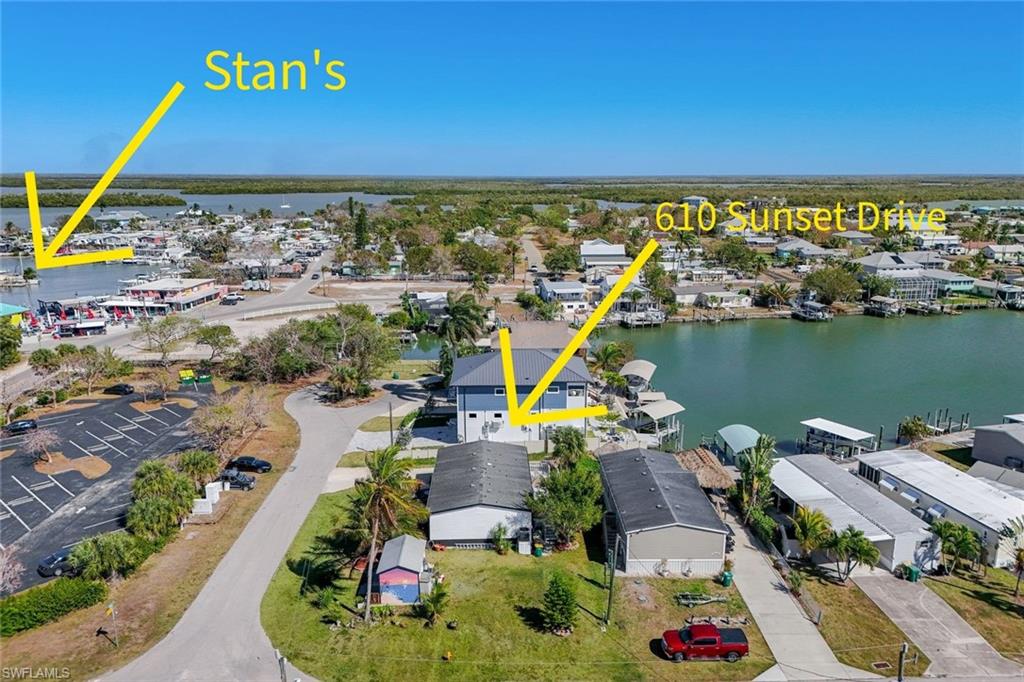 Discover the charm of island living in the heart of Goodland—where laid-back coastal vibes meet everyday convenience. This spacious 4-bedroom, 2-bath manufactured home sits on an oversized corner lot and offers the perfect blend of comfort and location. Enjoy vibrant live music from the legendary Stan's Idle Hour just seconds from your doorstep, and waterfront fun right around the corner. You’re also just minutes from Goodland’s beloved local restaurants and fresh seafood market, making it easy to savor the best of this charming fishing village. Inside, the home features impact windows for peace of mind, a bright and open layout, and a beautifully designed kitchen with a large island—ideal for gathering and entertaining. The spacious primary suite includes a walk-in closet, while three additional bedrooms provide flexibility for guests, a home office, or hobbies. Step outside to the large rear deck where you can relax and take in peaceful water views—perfect for morning coffee or sunset unwinding. The permitted shed adds valuable storage, and the generous corner lot offers extra space and privacy. If you’re looking for an inland property with water views, room to spread out, and unbeatable proximity to the best of Goodland, yet minutes to the beautiful beaches of Marco Island, then this is your opportunity to live the island lifestyle.