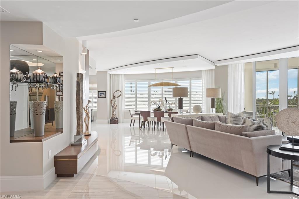 Expect to be impressed! This former model, which is truly extraordinary, has rarely been occupied. Being offered furnished with gracious custom details throughout, translate into elegant interiors. The private elevator opens to a dramatic living area featuring white marble flooring, a linear fireplace and tranquil views of the yacht harbor and private marina. The epicurean kitchen with stunning quartz countertops includes top-of-the-line Wolf appliances, gas cooktop, Miele dishwasher, Sub-Zero refrigerator and wine cooler. The primary bedroom boasts wide-plank wood floors, a custom-designed closet and an elegant spacious spa-like bath. This home also offers a spacious, private office.  Each guest en-suite bedroom provides a tranquil, private retreat. Aqua offers residents an amenity-rich lifestyle including on-site concierge service, fitness center, virtual game center, theater, putting green, dog run, social rooms guest suites, two parking spaces and so much more.