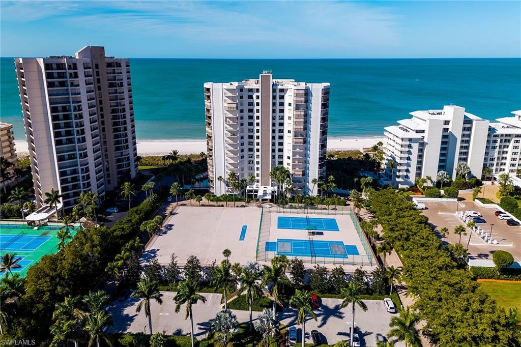 One or more photo(s) has been virtually staged, AI generated or rendered.  Experience stunning Marco Island sunrises and year-round sunsets from this spacious 3-bedroom, 3-bath Gulf-facing corner residence in the sought-after Marbelle Club. Multiple balconies showcase Gulf, beach, and skyline views. Freshly painted and designed for comfortable coastal living, the floor plan features expansive living and dining areas, a kitchen with breakfast nook, wet bar, laundry room, electric hurricane shutters, covered garage parking, and a private storage room adjacent to the unit. The primary suite offers two walk-in closets, dual vanities, and screened balconies, while two guest bedrooms provide privacy, full baths, and balcony access. 

Marbelle Club amenities include a beachfront pool and spa, tennis and pickleball courts, fitness center, sauna, shuffleboard, social and game rooms, grilling areas, and guest suites. Ideally located on Marco Island's desirable south beach, this beachfront community is close to dining, shopping, and entertainment. An outstanding opportunity to enjoy an elevated beachfront lifestyle in one of Marco Island's premier luxury communities.