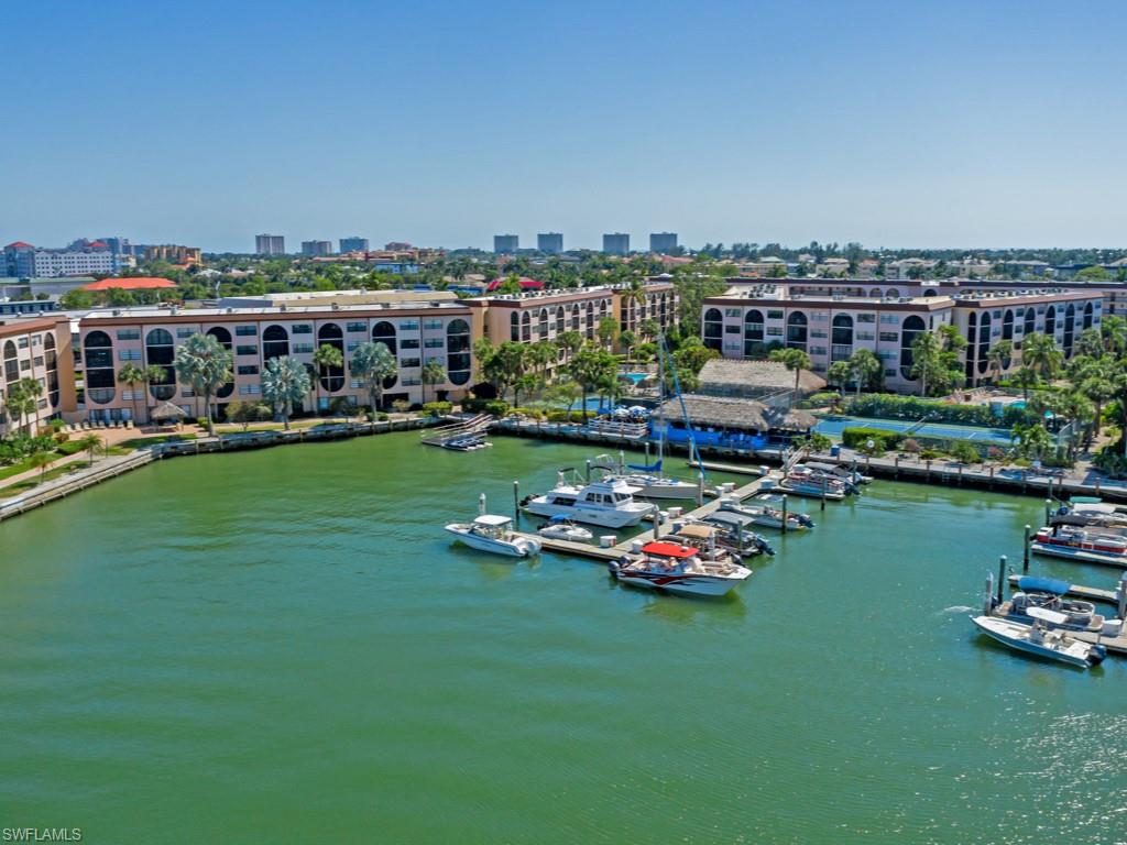 Experience the ultimate blend of island living, boating access, and income potential in this rarely available cabana residence at Anglers Cove. Offered furnished and move-in ready, this unique two-story condominium presents an exceptional opportunity for personal enjoyment, seasonal use, or investment, with the flexibility of weekly rentals allowing for outstanding rental potential. The thoughtfully designed main living area offers an open-concept layout ideal for entertaining and everyday coastal living. The kitchen features a center island with additional seating, flowing seamlessly into the living and dining spaces. The spacious primary suite provides generous closet space and is complemented by two updated baths with a fresh coastal aesthetic. Relax on the private screened lanai overlooking the community pool and tennis courts, creating a peaceful setting for morning coffee or evening unwinding. The versatile lower-level cabana adds valuable bonus space perfect for guests, a home office, fitness area, media room, or additional storage. Recent improvements include updated furnishings throughout, a newer air-conditioning system, newer water heater, and newer washer and dryer, offering convenience and peace of mind. Located within one of Marco Island's most popular waterfront communities, Anglers Cove offers resort-style amenities including two swimming pools, three spas, tennis courts, lush tropical landscaping, and the renowned waterfront Dolphin Tiki Bar & Grill. Owners also enjoy opportunities to lease boat and jet ski docks with direct access to the Marco River and Gulf of Mexico. Whether you're seeking a waterfront getaway, income-producing property, or full-time island residence, this distinctive cabana unit delivers an exceptional combination of location, flexibility, and lifestyle.