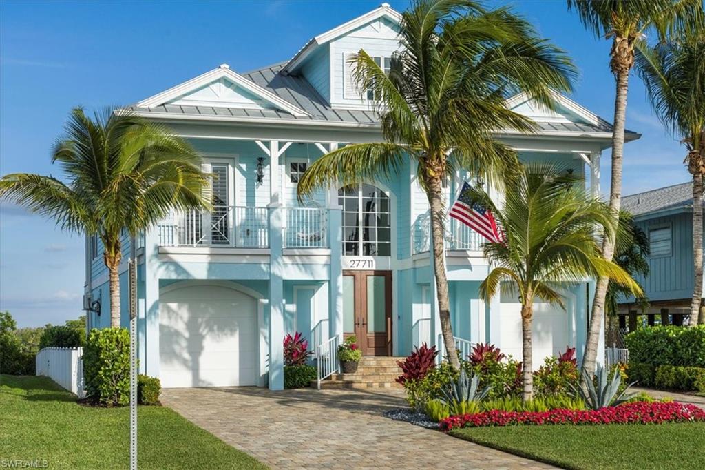 This immaculate coastal bay-front home offers the perfect blend of luxury and convenience. Just a short walk to the beach with a dedicated crosswalk, this premier boating property features a dock and lift, and offers serene bay views that stretch across to the picturesque mangrove islands. The high-quality construction boasts impact windows & doors, a metal roof, and concrete siding, ensuring peace of mind for the discerning buyer. The main level features by high ceilings, detailed millwork, coffered ceilings, custom railings, a wood staircase & beautiful flooring throughout. Your primary ensuite features dual vanities, claw foot tub and a separate shower. Each additional guest bedroom features their own full bathroom. The chef of the home will love entertaining from the kitchen with its own bay views. Step outside and enjoy the beautiful swimming pool and spa, perfectly situated on the bay, while the deep lot provides ample space. Relax and entertain on the spacious 40' screened lanai overlooking the pool and bay, perfect for al fresco dining! Boat dock & lift!
