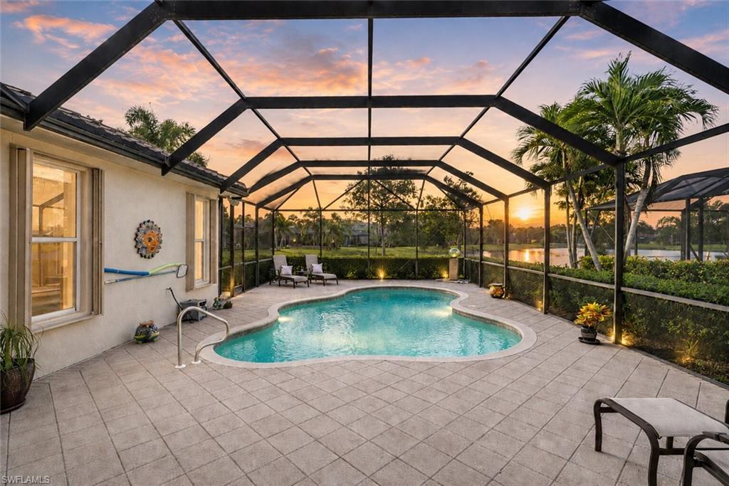 Positioned along a long lake view within Belle Lago, this Toll Brothers-built residence combines quality construction, thoughtful updates, and a highly functional floor plan in one of Estero's premier gated communities.

Offering 2,126 square feet with 3 bedrooms and 2 bathrooms, the home features a 2023 roof, impact-rated front and rear windows, an impact-rated front entry door, accordion storm shutters, natural gas service, and a heated private pool overlooking the lake.

Inside, crown molding and plantation shutters create architectural continuity throughout the home, while volume ceilings, tray ceiling details, and expansive living areas contribute to an open and inviting interior. Neutral finishes and large-format tile flooring through the main living spaces provide a timeless foundation for a variety of design styles.

The kitchen is centered around functionality and storage, featuring granite countertops, raised-panel wood cabinetry, stainless steel appliances, built-in wall ovens, and a natural gas cooktop. Adjacent dining and gathering spaces maintain strong visual connections to both the outdoor living areas and lake views beyond.

The primary suite is generously sized and includes a sitting area, tray ceiling detail, large windows, and an en-suite bath with dual vanities, granite countertops, a soaking tub, and a separate glass-enclosed shower.

Outdoor living serves as a focal point of the property. The screened lanai features a heated pool, covered seating areas, mature tropical landscaping, and long lake views that create a dynamic backdrop throughout the day. A dedicated natural gas connection is already in place for outdoor grilling.

Residents of Belle Lago enjoy access to a clubhouse, resort-style pool, fitness center, tennis courts, pickleball courts, and an active social calendar. One of the community's most distinctive features is direct golf cart access to Estero Country Club at The Vines, allowing convenient access to golf, dining, and additional club amenities.

Ideally located in the heart of Estero, Belle Lago is minutes from Coconut Point, Miromar Outlets, Southwest Florida International Airport, healthcare services, and Gulf Coast beaches.