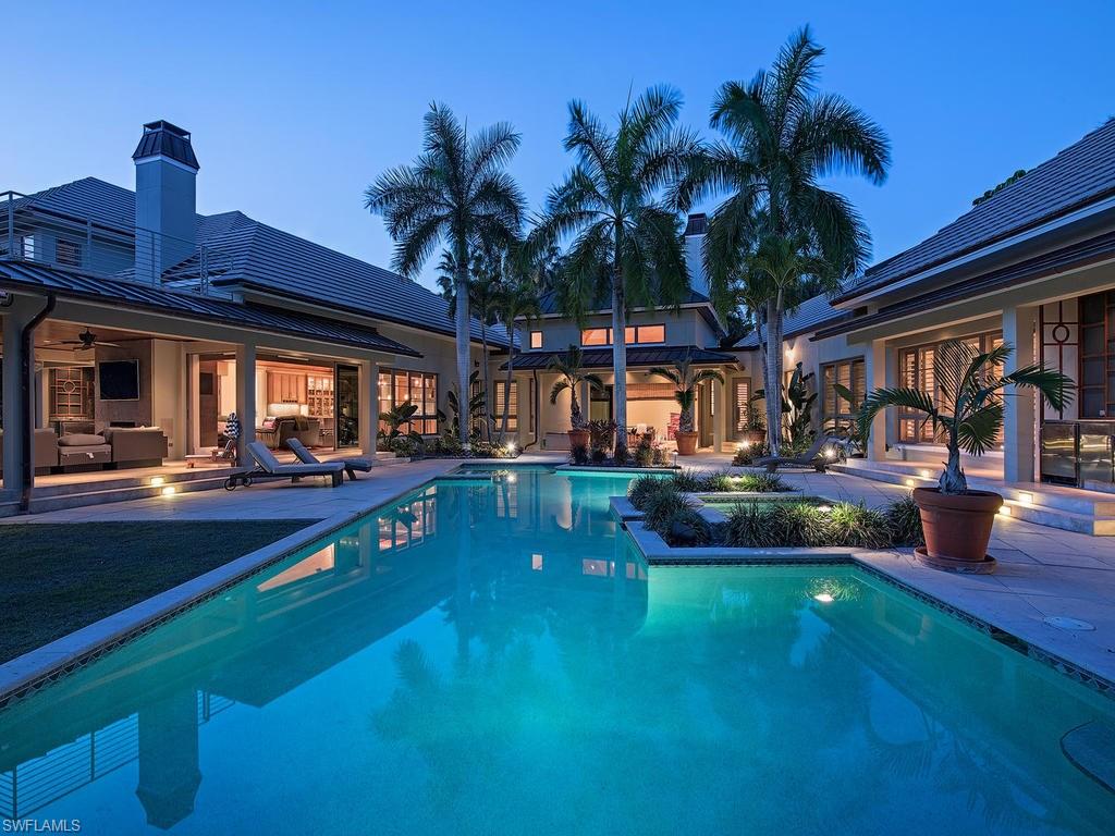 H.11580 - Spectacular Coastal Contemporary 5 Bedroom + Den home sprawls across its 7,009 Sq.ft. of living space with architecture reflecting clean, elegant lines and upscale finish.  This extraordinarily large lot is quietly sequestered on Yucca Rd, only 4 ½ blocks to the beach and has 185’ overlooking Naples Beach Club’s beautiful and newly renovated golf course.  The home boasts such features as soaring ceilings with tongue and groove pine, wood and marble flooring, 3 fireplaces, Lutron lighting, whole-home generator, Whole Home Automation, 3-car collector’s garage and much more.  The gourmet kitchen includes a butler’s pantry, top-of-the line appliances, large island and custom cabinetry.  The master bath is spectacular with its in-ground whirlpool spa, private shower with deluge head, natural rock water cascade and freestanding soaking tub.  Enjoy the 2nd floor with its very large media room and sun deck with big golf course views.  The resort like pool/spa is the perfect escape with a southern exposure, beautiful vistas, summer kitchen and covered or uncovered lounging locations. This property will be sure to impress even the most discerning of buyers.