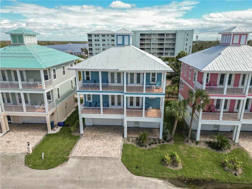 Welcome to Blue Dolphin, an exceptional Key West-inspired residence perfectly positioned in the heart of Fort Myers Beach. This impressive multi-level home offers 3 bedrooms, 2.5 baths, and an inviting blend of coastal elegance and island charm, complete with an assigned boat slip for effortless access to Estero Bay and the Gulf waters beyond.

Designed for comfortable living and entertaining, the interior showcases tile flooring throughout, a private elevator, crown molding, plantation shutters, and thoughtfully curated coastal finishes. The gourmet kitchen serves as the heart of the home, featuring stainless steel appliances, quartz countertops, a center island, custom cabinetry, breakfast nook, wet bar with beverage center, and a spacious walk-in pantry.

Outdoor living takes center stage with multiple balconies capturing beautiful bay views and refreshing island breezes. Additional highlights include a multi-car garage, community pool and cabana, and deeded beach access located at the end of Delmar Avenue—offering the best of both boating and beachside living.

Ideally situated just moments from Times Square, Bay Oaks Recreational Center, the public library, waterfront dining, shopping, entertainment, and the white-sand beaches that make Fort Myers Beach a sought-after destination. Whether as a primary residence, seasonal retreat, or investment property, Blue Dolphin presents an exceptional opportunity to embrace the ultimate Southwest Florida waterfront lifestyle.
