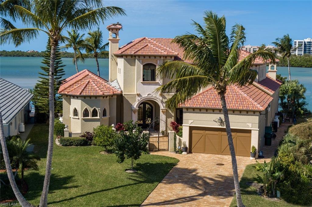 Spectacular Sunsets on Collier Bay in this 4BR 5Ba Home - Captivating Water Views Throughout! Gourmet Chef's Kitchen complete w/8-Burner Wolf Range & Double Ovens. Sub-Zero Refrigerator. Lg. Island offers Plenty of Prep Space! Walk-In Pantry & Wine Cellar. Stunning Mstr BR has Ornate Fireplace, Private Lanai w/Bay Views, 2 Walk-In Closets, Mstr Bath w/Walk-In Double Showers and Jetted Spa Tub. His/Her Vanities and commodes. 3 En Suite Guest Rooms w/Elevated Bay Views off the Wrap-Around Upstairs Balcony. Daily Dolphin Sightings! 2-Lift Large Dock which can accommodate both Lg/Sm. Vessels. Dock has Underwater Lights for Spotting Fish at Night. Minutes to Gulf/Beaches! Solid Concrete Construction w/New Roof, HVAC System, Brand New Hot Water Tanks, Arlo Security Cameras and Sonos Sound System throughout the House! Upstairs Game Rm. Custom Pool Table & Card Table, Large Family Rm off Kitchen Perfect for Entertainment! Lg Living/Dining w/Floor-to-Ceiling Glass with Magnificent Open Views to the Bay. Woodburning FP. Resort Quality Pool/Patio/Lounge Area with Infinity Pool and Spa. Large 3-Car Garage. Impeccable Landscaping complete with Citrus and Avocado Trees. Your Island Oasis Awaits!