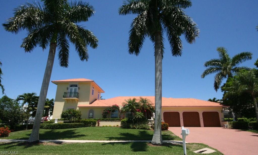 Updated & expanded home in great neighborhood with tile t/o.  Kitchen and guest bath remodeled. Master bedroom enlarged. Master Bath addition and 2nd story added in 2000.  Elevator to 2nd story (den/studio) w/2 balconies & views to Collier Bay.  2 walk-in closets in Master.  Master Bath has his & her vanities, large shower & Roman tub. 3 car garage.  Storm protected w/impact glass, manual & electric shutters.