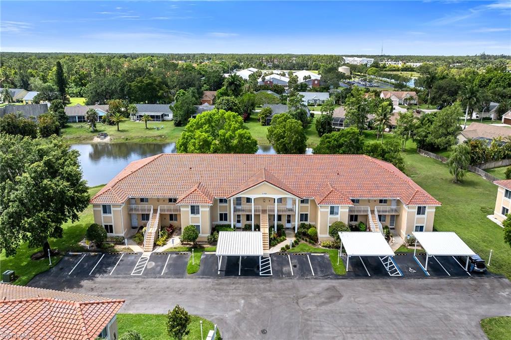 Enjoy peaceful lake views from this beautifully maintained first-floor condominium, offering a serene waterfront setting and a comfortable lifestyle in one of Naples' desirable communities. Natural light fills the home, creating a bright and welcoming atmosphere while showcasing the tranquil water views. With a thoughtfully designed three-bedroom, two-bath floor plan and one assigned carport space, this residence is ideal for seasonal or year-round living. The interior features laminate flooring throughout the main living areas and primary bedroom, with carpet in the guest bedroom for added comfort. The spacious living room is enhanced by abundant natural light and sliding glass doors that open to a glass-enclosed lanai, creating the perfect space to relax, entertain or enjoy the picturesque lake views in any season. Adjacent to the living area, the dining-living room combination provides an open and functional layout. The kitchen has been thoughtfully updated with custom cabinetry and a suite of appliances, including a new refrigerator/freezer with icemaker, a dishwasher and a microwave, providing both style and convenience for everyday living. The primary suite serves as a comfortable retreat featuring laminate flooring, a ceiling fan, a generous walk-in closet and an ensuite bath complete with a glass-door shower/tub combination. The guest bedroom offers a ceiling fan, closet space and plush carpeting, making it ideal for visitors or a home office. A full hallway bath with a glass-door shower/tub combination provides additional convenience for guests and residents alike. A dedicated laundry area includes a washer and a newer Samsung dryer, adding to the home's practical appeal. The glass-enclosed lanai extends the living space and provides a relaxing setting to enjoy morning coffee or unwind while overlooking the water. Residents enjoy access to a variety of community amenities, including a sparkling community pool, bocce courts and tennis courts, all within beautifully maintained grounds. Conveniently located near shopping, dining, golf and Naples' renowned beaches, this lakefront residence presents an exceptional opportunity to enjoy the Southwest Florida lifestyle.