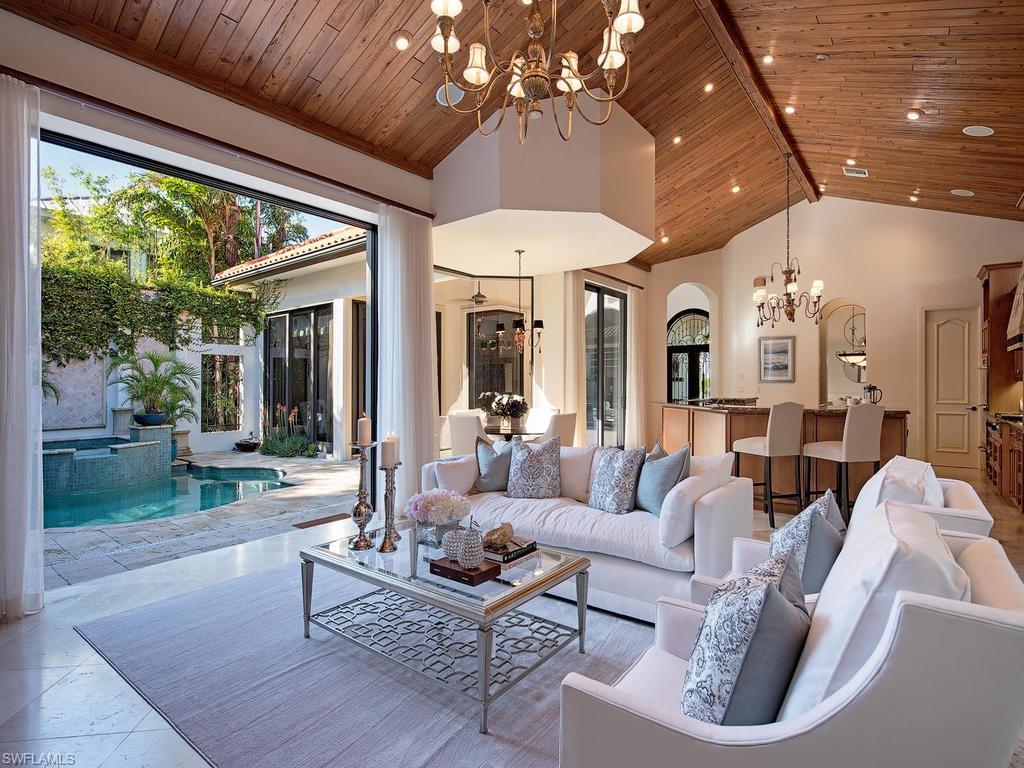 H.14286  Stunning custom built courtyard home. Only one block to the world renowned elegant Third Street South for shopping and fine dining. The ideal Naples retreat with privacy in mind. Spacious owner's suite has a large sitting area, two walk-in closets, large "Jacuzzi" soaking tub, walk in shower and two vanities. Easy access to the pool and spa, and outdoor entertaining areas. The two guest suites, one a cabana off the pool, were designed for your guests to enjoy their privacy in comfort and style. Walk-in wine room off the formal dining room, a butlers pantry between the true chef's kitchen that features gas cook top, two sinks, large island with ice maker, and a walk-in pantry. Vaulted ceiling in the Great room features tongue and groove "pecky" cypress ceiling, gas fireplace and large windows to let in light and air. Private den/study at the front of the home has beautiful builtins. Large bonus room upstairs. Two covered outdoor living areas, one with a fireplace and kitchen.