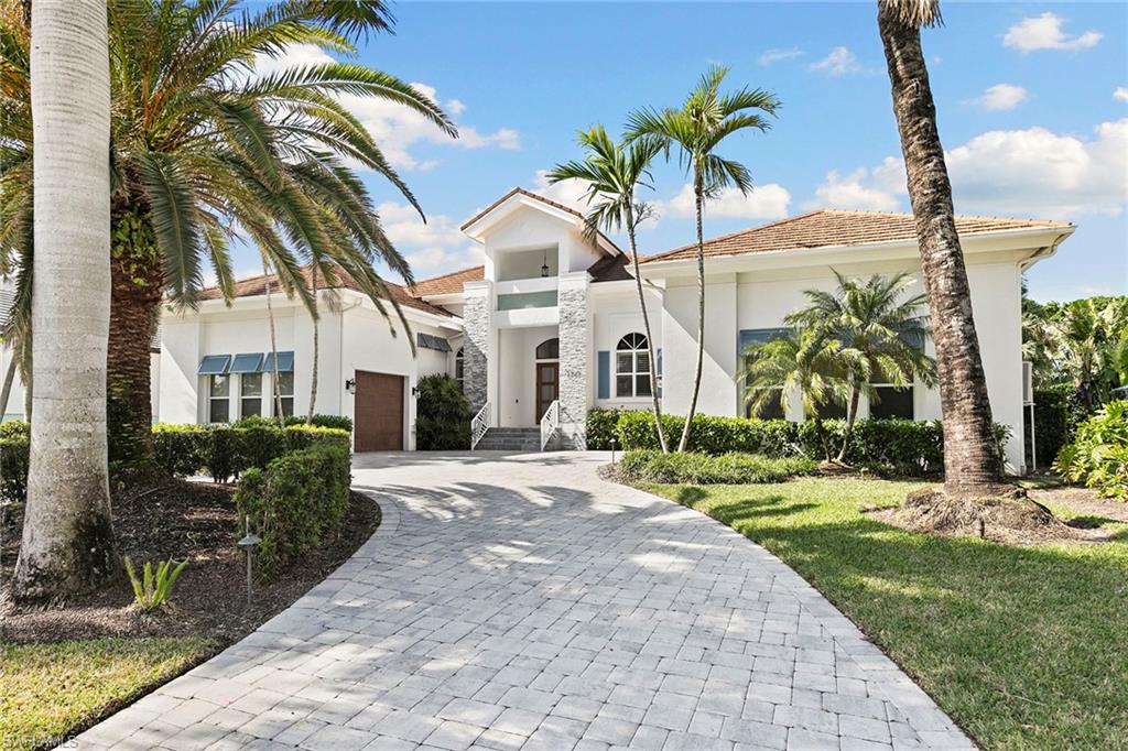 JUST REDUCED! HOME NOW PRICED AT $700K BELOW RECENT CARROLL & CARROLL APPRAISAL. This beautiful 2010 single-family home in the prestigious Park Shore neighborhood of Naples has been thoughtfully redesigned and updated throughout with luxurious finishes, and offers an open-concept floor plan featuring four bedrooms, three and a half baths, a study, and a formal dining room. Step inside to soaring ceilings, where the great room captivates with vaulted beams and an elegant built-in fireplace. Sliding doors across the whole back of the house overlooking the pool area. The adjacent chef’s kitchen is a masterpiece, showcasing quartz countertops, lighted display cabinets, a built-in stainless-steel refrigerator, a 5-burner gas stovetop, a double wall oven, and a wine cooler—ideal for effortless entertaining. The sophisticated study features exquisite trimwork and a coffered ceiling, creating an inspiring and versatile space. The primary suite serves as a serene retreat, complete with a spa-like ensuite bath, oversized walk-in closets, and private access to the outdoor living area. Designed for seamless indoor-outdoor living, the expansive screened lanai boasts an outdoor kitchen, a covered lounging area, and a saltwater pool and spa, all enveloped by lush tropical landscaping. Additional highlights include high quality surround sound, whole-home water filtration system and exterior leaf guards for enhanced comfort and convenience. Air conditioned garages for three cars - complemented by a circular paver driveway providing extra parking. Residents of Park Shore enjoy eligibility for membership in the Park Shore Association, offering exclusive beach park access and an unparalleled Naples lifestyle. Venetian Village is less than a mile away, providing upscale shopping, waterfront dining, and breathtaking bay views. This home is a must see!