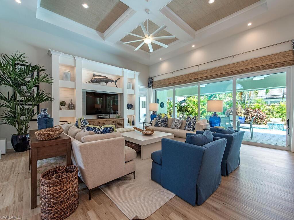 This home has been masterfully remodeled and is located on on a quiet cul de sac lane. Lovely natural lighting floods this executive home. The stunning kitchen features a large island, Kitchen aid appliances, separate U-line ice maker, with EJB custom cabinetry. The windows, sliding glass doors and Mahogany front door are all hurricane impact rated. Wood beams and an extensive wood trim with furniture grade finish enhance the open concept floor plan. Bay Design furniture and other high end furniture elevate the aesthetic appeal to the home.  Open the sliding doors and enjoy the glass tiled spa and pool with spillover fountains. Enjoy entertaining outdoors while grilling at the convenient summer kitchen area. The outdoor area also features an electric fireplace, propane gas fire pit and a Sun Brite outdoor TV. A Sonos sound system is available throughout the main area of the home and on the lanai. Security features include hard wired Ring cameras and a keyless entry garage. This house is the perfect oasis to shut out the noise of the world and relax.