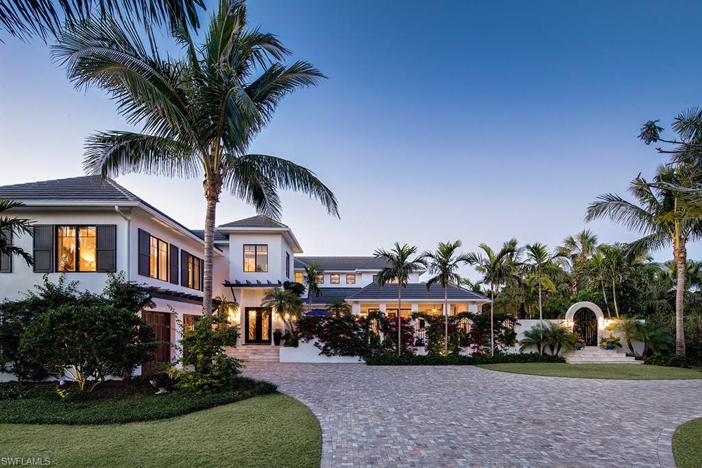 A sophisticated home masterfully executed by the team of Kukk Architecture and Design, P.A. and A. Vernon Allen Builder, Inc. Comfortable inner spaces flow with calming transitional areas to enjoy the lush surroundings of an exceptionally large Old Naples property (.6 acres per plat and deed) which is just a stroll to the Gulf of Mexico. The chef’s kitchen with hand-crafted zinc hood, twin islands and a 60” Wolf stove make it a space for both serious cooking and for entertaining. The generous master suite offers separate bathrooms, steam shower, deep-soaking tub, wet-bar, walk-in closet and sitting room. Enjoy your morning coffee on the master balcony overlooking a mango tree and lush tropical landscaping. The outdoor kitchen and adjacent sitting area, with motorized screens and hurricane shutters, provide the perfect outdoor gathering area. This stunning home comes equipped with a full-house 48 KW generator, water filtration system, impact windows and doors, an elevator which stops at all levels, laundry facilities on the main and upper levels, and Lutron lighting.