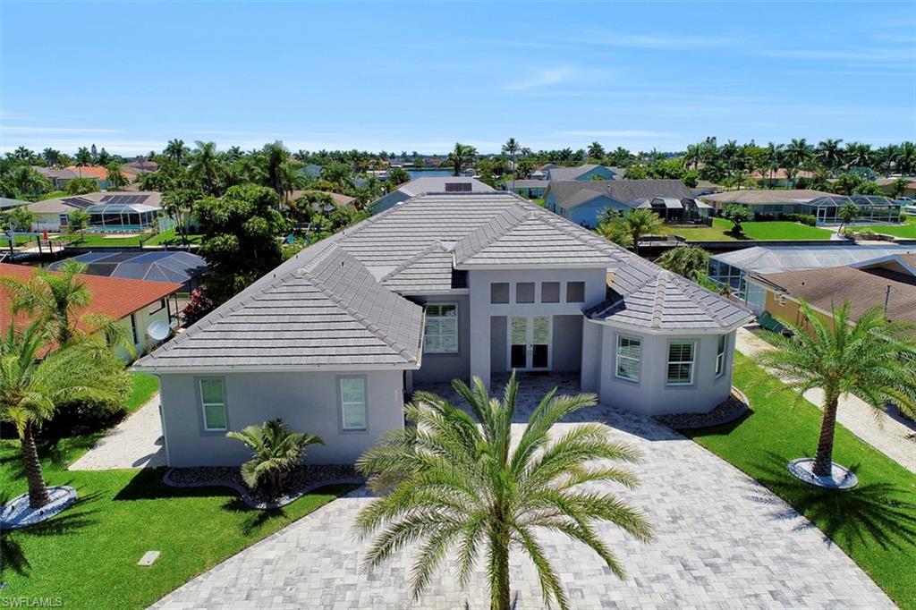 ONE OF A KIND CUSTOM BUILT GULF ACCESS  WATERFRONT  HOME WITH NO BRIDGES!!!! You will be IMPRESSED and AMAZED with all this home has to offer. This Home Is IMPECCABLE And The Upgrades Speak For Themselves!!! This Home Has 3 Bedrooms + Den 3 Bath and 2 Car Garage Has Approx 3560 Total Area. At First Glance You Will Notice The Beautiful Upgraded Landscaping With Marble Gravel, Landscaped Lighting, Palm Trees and Modern Tile Roof. Some Of The Upgrades Include: Security System With 6 Outside High Resolution Cameras As Well As An Alarm System Throughout The Home, 12' High Ceilings, Crown Molding, Tray Ceilings, Impact Glass On Windows and Doors, Heated Pool and Spa, Outdoor Shower and Outdoor Kitchen.   This Home Also Has Stainless Steel Appliances, Moen Fixtures and A Wetbar Area With Italian Cabinetry and MANY MANY More Features  Including Your Custom Built Concrete Dock!!!! CALL AND SCHEDULE YOUR VIEWING TODAY!!