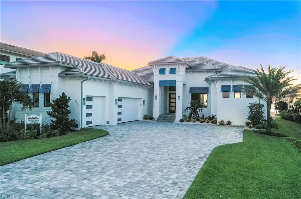 Welcome to your dream waterfront oasis in the heart of Cape Coral's prestigious Palaco Grande neighborhood! This stunning New Construction 2023 home boasts Direct Gulf Access, perfect for avid boaters and water enthusiasts. Designed and masterfully crafted by Edge Water custom builders, this luxury coastal contemporary masterpiece redefines waterfront living. As you enter, you'll be greeted by the grandeur of 12 to 16 foot ceilings with Knotty Adler Wood Beams. This home features an entertainer's dream kitchen with top of the line wolf gas cooktop appliances, quartz countertops and premium finishes. A hidden door leads to the butler's pantry, enhancing the functionality & use of the home. Four ensuite bedrooms, half bath, plus a den. American Hickory Natural Wood wide plank Floors throughout. Tongue and Groove Southern Pine Wood ceiling inlays. The outdoor living space combines the soothing elements of fire and water to create an oasis of relaxation. Enjoy miles of Beautiful water front views as you barbecue in your summer kitchen with a gas grill. Entertain guests in front of the gas fire pit feature or gas fireplace with a pool, spa and outdoor dining.  A lifestyle destination.