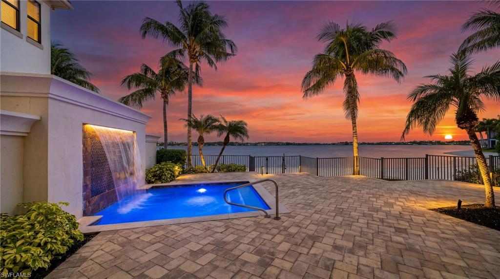 Experience the pinnacle of luxury waterfront living in this custom designed 4 bedroom, 4.5 bath estate, perfectly positioned on a pristine private beach with coveted southern exposure. Located within one of the nation's premier luxury communities, this exceptional residence showcases exquisite craftmanship, sophisticated finishes, and breathtaking water views from nearly every room. Designed for both elegant entertaining and relaxed coastal living, the home features expansive indoor and outdoor living spaces, with a beautiful outdoor summer kitchen overlooking the beach. This is a rare opportunity to own a truly extraordinary home in one of the most sought-after luxury communities, where world-class amenities and breathtaking natural beauty come together to create an unmatched living experience. Miromar Lakes Beach and Golf Club offers 700 acres of freshwater lake and 3 miles of white sand beach, 2 marinas, beach club, country club dining, spa, fitness, bocce crt, golf, tennis and pickleball. Miromar Lakes "Live Life on Your Time.
