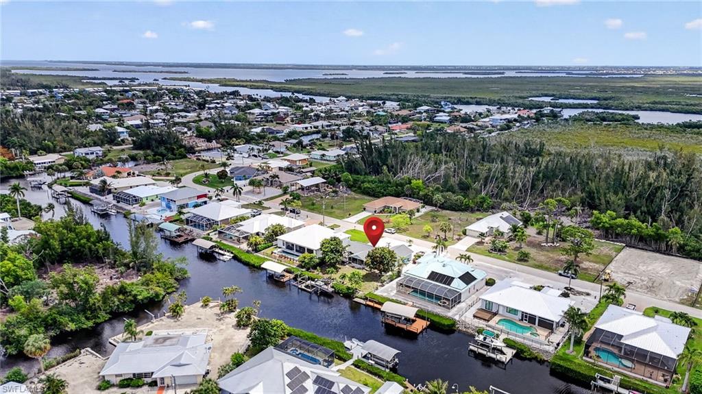 DISCOVER AFFORDABLE GULF-ACCESS LIVING ON BEAUTIFUL PINE ISLAND

Imagine ending each day with breathtaking island sunsets shimmering across the canal, tropical breezes drifting through your Florida room, and your boat waiting just steps from your back door. This Gulf-access waterfront retreat offers the laid-back coastal lifestyle so many dream about—without the premium price often associated with waterfront living.

Inside, soaring ceilings and an open, light-filled floor plan create an inviting atmosphere that feels both spacious and relaxed. Large living areas flow effortlessly into the Florida room, where tranquil water views provide the perfect backdrop for morning coffee, evening cocktails, or simply enjoying the peaceful surroundings.

For boating enthusiasts, the double-lift dock offers quick access to the Gulf of Mexico, placing world-class fishing, secluded beaches, waterfront dining, and Southwest Florida’s barrier islands within easy reach. The expansive backyard provides ample space to create the custom pool oasis you’ve always envisioned, while mature tropical landscaping and producing mango trees add privacy, beauty, and authentic island character.

With just a few personal touches, this property has the potential to become an exceptional waterfront getaway, full-time residence, seasonal retreat, or investment opportunity. Located in a quiet waterfront community with access to a private neighborhood boat launch available through a low annual membership, you’ll enjoy the very best of Pine Island’s relaxed and natural lifestyle.

Waterfront opportunities with this combination of Gulf access, outdoor space, and potential are becoming increasingly difficult to find. Schedule your private showing today and experience the island lifestyle for yourself.