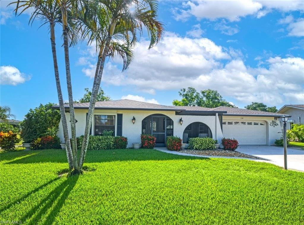 This well-maintained home with a BRAND NEW ROOF has custom design choices throughout that elevate the interior living space. The millwork for instance, with crown molding, baseboards, and wainscoting, provides the main living areas and master suite with a stylish polished feel. The large Florida room is surrounded by windows that fill the home with light. There is a cozy screened-in front porch for chatting with the friendly neighbors and a more private screened-in back lanai that is perfect for enjoying the Gulf breeze while doing a crossword puzzle. The kitchen has its own charm, with Silestone engineered-quartz counters, stainless steel appliances, a moveable island for extra counter/storage space, a new dishwasher, and an eat-in breakfast nook. You'll find no wasted space with this floor plan. The flooring is Pergo vinyl in the living room and master bedroom (2025). The kitchen and Florida room floors are tiled. The water heater is newer (2024) and there is a Kinetico water filtration system for the whole home. The well for lawn irrigation drastically reduces the water bill. Some of the windows are impact glass and the others have storm shutters (electric in the Florida room). Practical extras abound, including a widened driveway for easy guest parking. The sale includes 2 TVs and tasteful decor. When you walk through the front door, you'll know the home is the definition of move-in ready. Riviera Golf Estates has one of the lowest HOA fees in Naples: $144/mo. (includes basic internet). That's not to say there aren't an abundance of community amenities, which include a heated saltwater pool with lap lanes, a tiki hut, tennis/pickleball/bocce courts, exercise room, billiards room, shuffleboard, and a large clubhouse with an active social calendar. All this and you are only eight miles from the beach and just a ten-minute drive from the shops on 5th Ave. Come have a look and see what you think. This home does NOT disappoint!