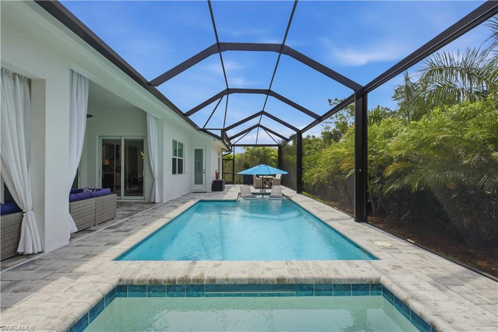 Built in 2022 by FCI Homes, this exceptional Saint Vincent floor plan offers a sophisticated blend of modern design, quality construction, and effortless indoor-outdoor living. Ideally positioned with desirable southern exposure, this meticulously maintained residence showcases an expansive screened outdoor retreat featuring a saltwater pool and spa with a cascading waterfall fountain, brick paver deck, and panoramic screen enclosure that frames the lush tropical landscape. Thoughtfully designed for both comfort and entertaining, the open-concept floor plan is enhanced by soaring tray ceilings, abundant natural light, impact-resistant windows and sliders, custom Hunter Douglas shades, Minke fans, and elegant finishes throughout. The kitchen serves as the heart of the home, offering a spacious island, ample cabinetry, pantry, that seamlessly flows into the living and dining areas. Additional sound insulation between the living room and primary suite provides enhanced privacy and everyday comfort. The luxurious primary suite offers a peaceful retreat, while guests enjoy well-appointed accommodations. Practical upgrades include extra storage in the laundry room, a whole-house surge protector, and a Generlink system installed at the meter, allowing a portable generator to power the entire home when needed. Outside, extensive tropical landscaping creates a private oasis, complemented by a 5-foot chain-link fence ideal for pets or added peace of mind. Situated at an elevation of approximately 10.1 feet, this residence combines beauty, functionality, and quality construction in one of Marco Island's most desirable settings. A rare opportunity to enjoy newer construction, premium upgrades, and resort-inspired outdoor living in a private tropical environment.