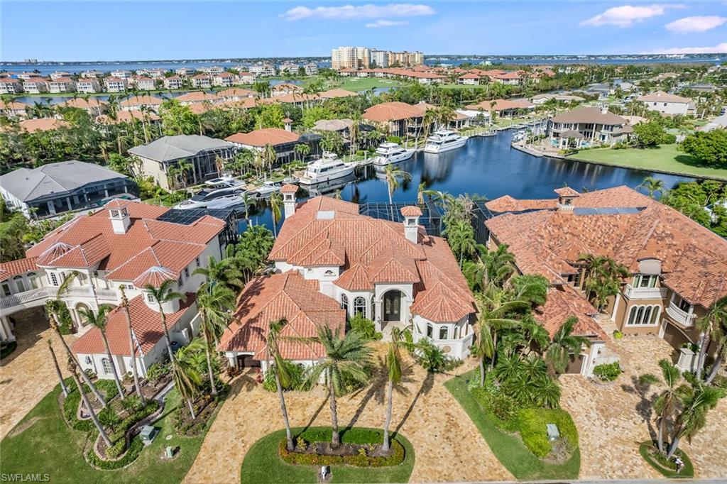 Over the Top Waterfront Home in the Best Boating Deep Water Community in SWFL, Palmetto Point. Gorgeous residence w/4 bedroom suites all w/baths. This home has it all. Features include marble, granite, gold fixtures, HUGE outdoor living area w/bamboo ceiling, BBQ; 3 ice machines, custom built-ins, designer area rugs, drapes, 2 outdoor spa's, large pool. Gourmet kitchen w/Wolfe Appliances; A/C workshop, 3 car garage, elevator, Media/Billiards room, new roof. concrete floating dock for 95'+ Yacht. This home is MOVE IN Ready!