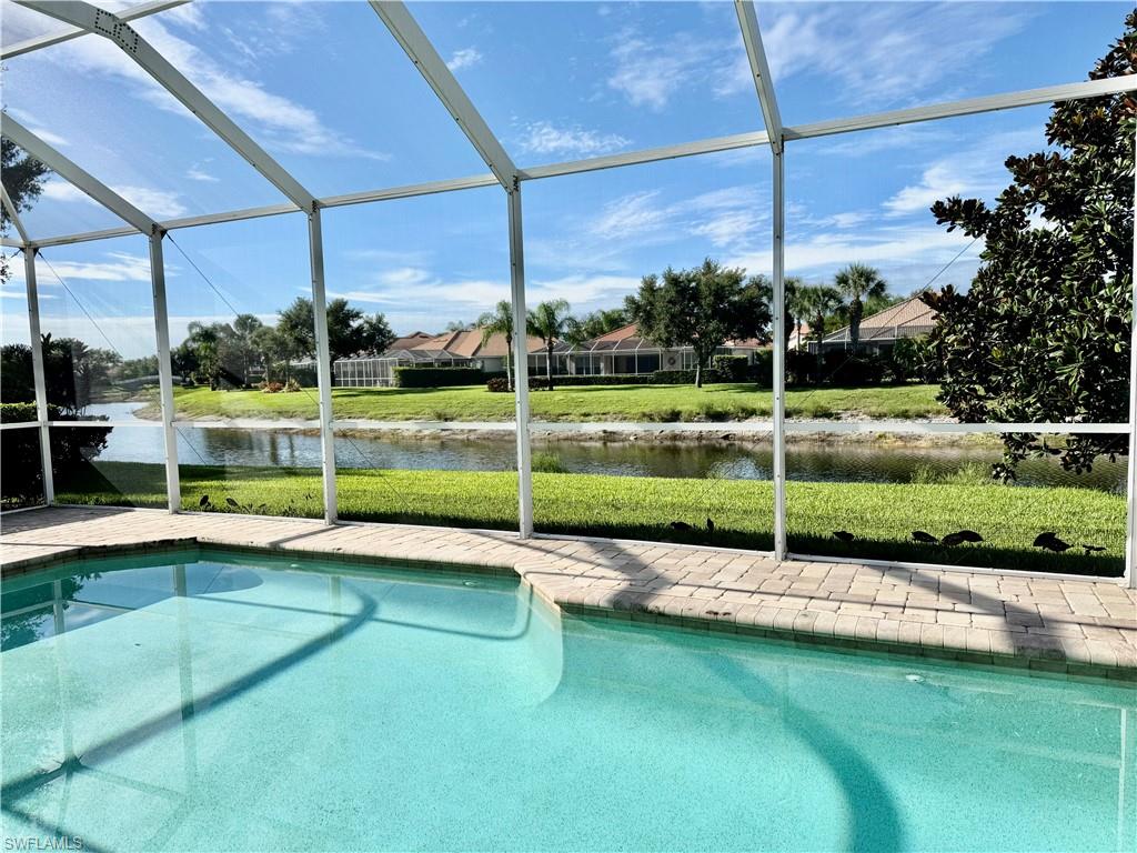 Beautifully maintained 2-bedroom plus den, 2-bath pool home with outstanding curb appeal, lush tropical landscaping, a paver driveway, and an inviting screened entry. Inside, you'll find warm wood flooring in the bedrooms and large diagonal-laid tile throughout the main living areas, creating an elegant and timeless look. The light-filled split-bedroom floor plan offers spacious living areas designed for both everyday comfort and effortless entertaining. AC new in 2024.Step outside to your own private screened pool and lanai, the perfect setting for morning coffee, outdoor dining, or relaxing in the Florida sunshine. Pride of ownership is evident throughout, making this home truly move-in ready. Other features include a finished walk-in closet with California Closet concept in the master bedroom and finished flooring and elevated lift storage (with battery backup) in the garage. Enjoy an exceptional resort-style lifestyle with outstanding community amenities, including a beautiful clubhouse with restaurant, resort-style and lap pools, fitness center, tennis, pickleball, bocce, basketball, library, hobby and community rooms, beauty salon, scenic walking and biking paths, playground, vehicle wash area, and a full calendar of social activities. This home offers the perfect combination of comfort, style, privacy, and an active Florida lifestyle.