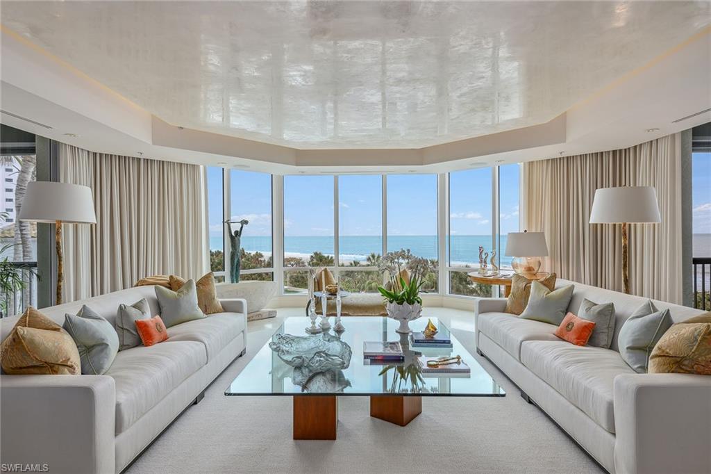 Directly on the pristine sands of the beach in the prestigious, private, gated enclave of Bay Colony. The Windsor epitomizes luxury coastal living. Upon arrival, the private elevator opens to reveal breathtaking uninterrupted panoramic views. The residence boasts an impressive 6155 square feet of thoughtfully designed living space, complemented by three generous lanais inviting you to savor spectacular sunrises and sunsets every day of the year. The meticulously crafted floor plan includes a luxurious primary suite with dual baths, three guest bedrooms with en suites, a versatile office, and a chef's kitchen that seamlessly flows into the inviting family room and breakfast nook. The decor and style have been expertly created by renowned Naples interior designer Judith Liegeois Designs. The Windsor has undergone a complete transformation offering unparalleled amenities designed to elevate every aspect of your lifestyle. These include 24-hour staffed concierge desk, a well-appointed conference room and elegant social lounge, a resort-style pool, a state-of-the-art fitness center and three charming guest villas for your visitors.