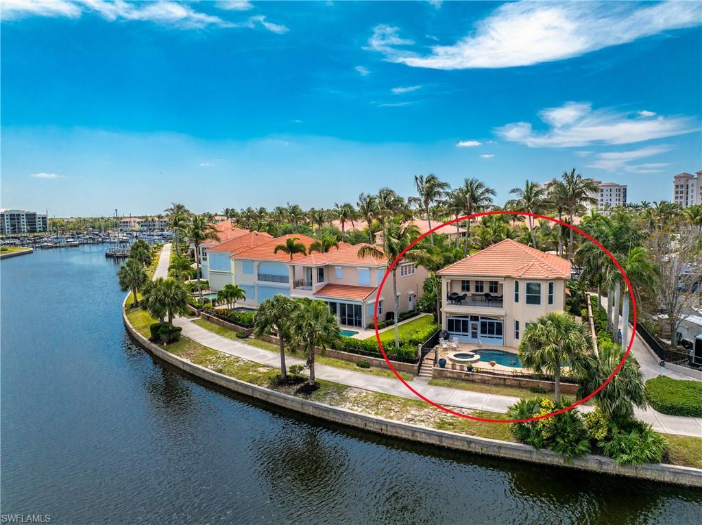 This beautifully updated waterfront pool home captures the essence of refined resort living. You will experience an incredible sense of arrival as you approach this gated waterfront peninsula flanked by majestic Royal Palm trees with live oak trees leading you home. A paver drive and pathway will welcome you through a charming entry courtyard and into a dramatic interior, where soaring two-story ceilings and abundant windows create an immediate sense of light and openness. Live your vacation everyday as you watch boats sailing by, people out for a morning jog, or an evening stroll… and know you have landed in just the right place! Here you will be embraced by neighbors enjoying the best of what Burnt Store has to offer. This well maintained residence boasts pristine diamond-set tile throughout the main living areas and a soft, cohesive palette. At the heart of the home, the updated kitchen blends style and performance with new quartz countertops, a spacious center island with seating, and brand-new stainless steel appliances (2026), including a double conventional/convection wall oven, cooktop, and refrigerator. A sunlit dining nook overlooks the private courtyard, while the adjacent living and dining spaces rise two stories high, framing picturesque views of the pool and waterfront beyond. Crown molding adds a refined finishing touch. The first-floor primary suite is a true retreat, privately positioned to capture tranquil water views and direct access to the enclosed lanai. A tray ceiling enhances the sense of space, while the ensuite bath features a walk-in closet, updated dual vanity with stone tops, a garden tub, and a glass-enclosed shower. A den or fourth bedroom and full bath — conveniently serving as a pool bath — complete the main level. Upstairs, two bedrooms and a full bath provide superb accommodations for guests. One oversized bedroom is a standout, featuring French doors, a built-in entertainment center/closet system, tray ceiling, and expansive windows overlooking the marina channel. Sliding doors open to a private, second-story lanai with new motorized storm screens — an ideal vantage point to unwind while watching boats drift by. The other bedroom offers generously sized quarters…both with access to the updated bath with new shaker style vanity with quartz tops and tub/shower combo. The magnificent outdoor living space impresses with a new expansive paver pool deck surrounding a freeform pool and spa, resurfaced with PebbleTec and updated coping in December 2023. The enclosed lanai, finished with tile and a summer kitchen, creates a seamless extension of the living space. Step directly onto the marina walking path outside your back door for effortless waterfront access. Additional upgrades include a NEW ROOF & soffits (2024), hurricane resistant garage door, impact-resistant windows (most-2023) and Kevlar electric roll-down screens on both upper and lower lanais — offering protection without compromising views.