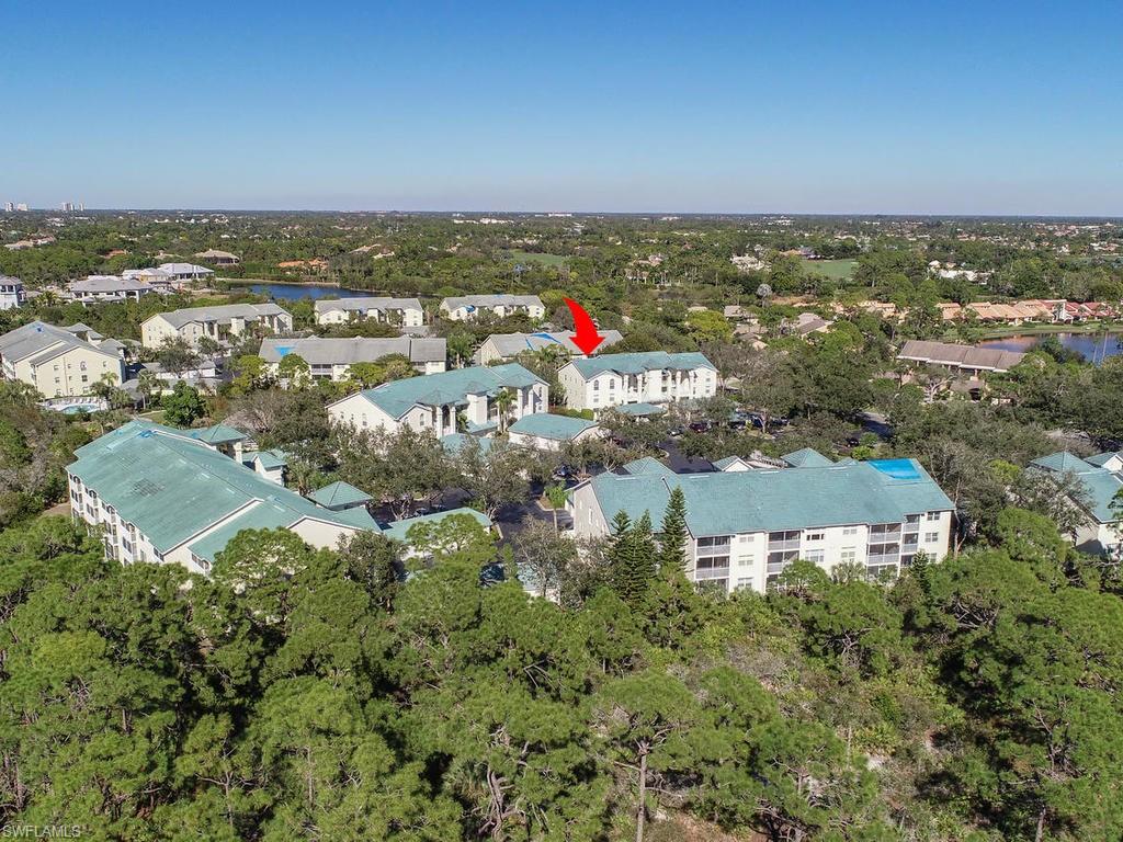 JUST REDUCED! BRING ALL OFFERS to purchase a TURNKEY FURNISHED, RARELY AVAILABLE TOP FLOOR END UNIT with SOARING VAULTED CEILINGS! This Bimini floor plan in Bermuda Bay I is very quiet, light, bright & airy with three walls of windows. The main living & dining areas are all tiled and open into the tranquil screened lanai. The generous master suite has an en suite bathroom & a large closet & also opens into the lanai. The guest suite features a comfortable sized bedroom, bathroom with linen closet & large hallway storage closet. The cheery kitchen is well equipped & has a table & chairs, large pantry, plenty of storage, vaulted ceilings & plant shelves. A full sized side-by-side washer & dryer is in the unit & a dedicated, covered carport is just outside. Both stairs & a common elevator lead to the unit. Bay Forest amenities include lush landscaping, walking trails, a boardwalk with a tiki hut that extends over the backwater of the Gulf of Mexico with access for paddle boards/kayaks, bocce ball, tennis, pickleball, shuffleboard, community pool, fitness center, community center, library & numerous social events. WEST OF 41 & MINUTES TO THE BEACH!
