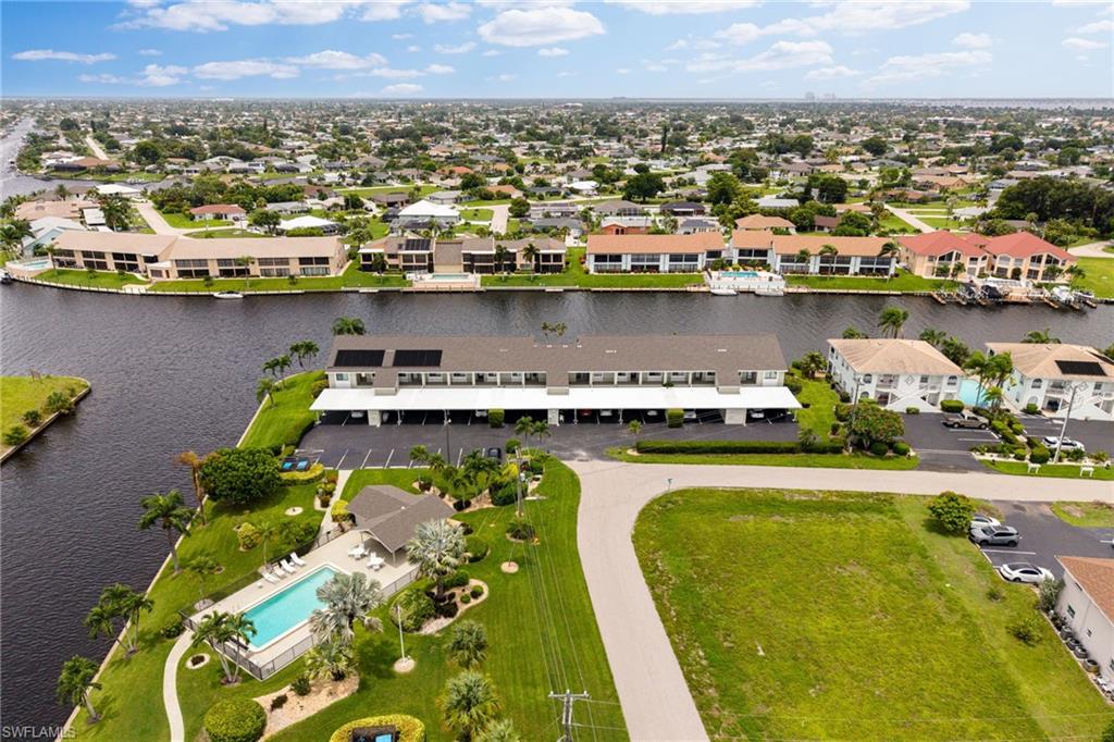 Boater's Paradise in the heart of Southeast Cape Coral! Enjoy Gulf access and beautiful wide canal views from this well-maintained second-floor, 2-bedroom, 2-bath condo in the desirable Harbourtowne Condo of Cape Coral community. Relax on your screened lanai overlooking the water, or spend the day on the boat with convenient Gulf access from the community dock. Inside, you'll find a spacious split-bedroom floor plan, an open living and dining area, and a well-appointed kitchen with granite countertops. Covered parking and two private storage units provide plenty of space for your beach gear and boating essentials. Harbourtowne offers a large heated waterfront pool, beautifully maintained grounds, and affordable condo fees, all in an unbeatable SE Cape location just minutes from downtown Cape Coral's restaurants, shopping, entertainment, The Bimini Basin area, and The Cape Coral Yacht Club. Whether you're looking for a year-round residence, seasonal retreat, or investment opportunity, this waterfront condo is ready for you to start enjoying the Southwest Florida lifestyle.