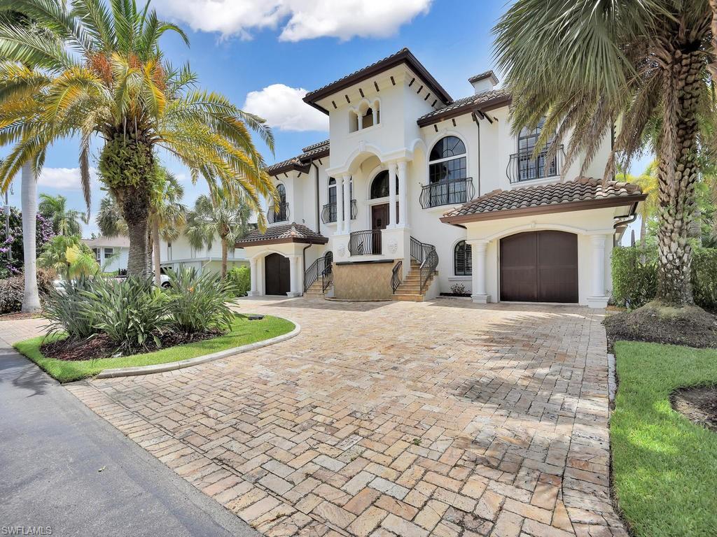 Palatial Waterfront Home with Direct Deep Water Sailboat Access to the Gulf of Mexico. Tile floors throughout. Carpet and Hardwood. Highest Grade Appliances. Custom Crown Molding. Tropical Lanai with beautiful Heated Pool and Spa. Two expansive Balconies with a 4th floor Observation Deck. You can see all the way to the Gulf Of Mexico. 10,000 lb Boat Lift, Plus with 50' Dock. Elevator from garage level to 3rd floor. First Level Has Three Car Garage, Fitness Room, Theater Size Movie/Screening Room with 120" Drop Down Screen and Projector, Large Service Bar, Two Bedrooms and Oversize Bathroom. Main Level has Great Room with Fireplace, Beautiful Formal Dining Room, Office/Study, Custom Kitchen with Center Island, Granite and Stainless Appliances, Kitchen Nook, Walk In Pantry, Laundry Room Half Bath, Master Bedroom Suite Master Bath Jacuzzi Tub, Large Shower with Tile Bench Seat, and His and Hers Vanities. 3rd Level has 2cd Master Suite, Guest Bedroom and Bath. 4th level deck. Palm Isles Has Royal Palms lining both sides of the street. All homes are Waterfront. Just 20 minutes by Boat to the Gulf of Mexico. There are only 68 homes in this Gated Enclave. VIRTUAL TOUR available.